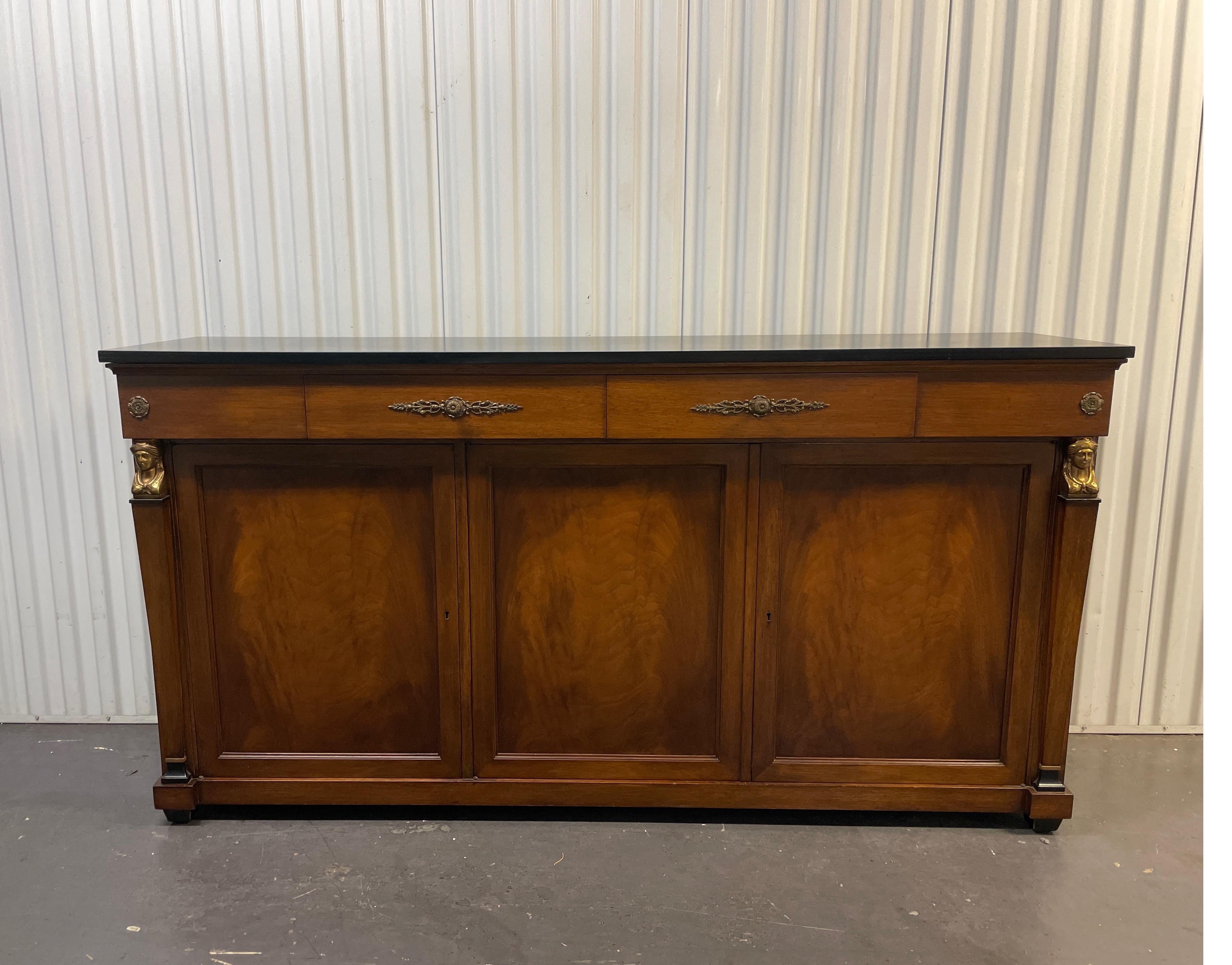 Vintage Neoclassical style sideboard with two drawers over three doors. Rich walnut color base with black painted top. Adjustable shelves for ample storage.