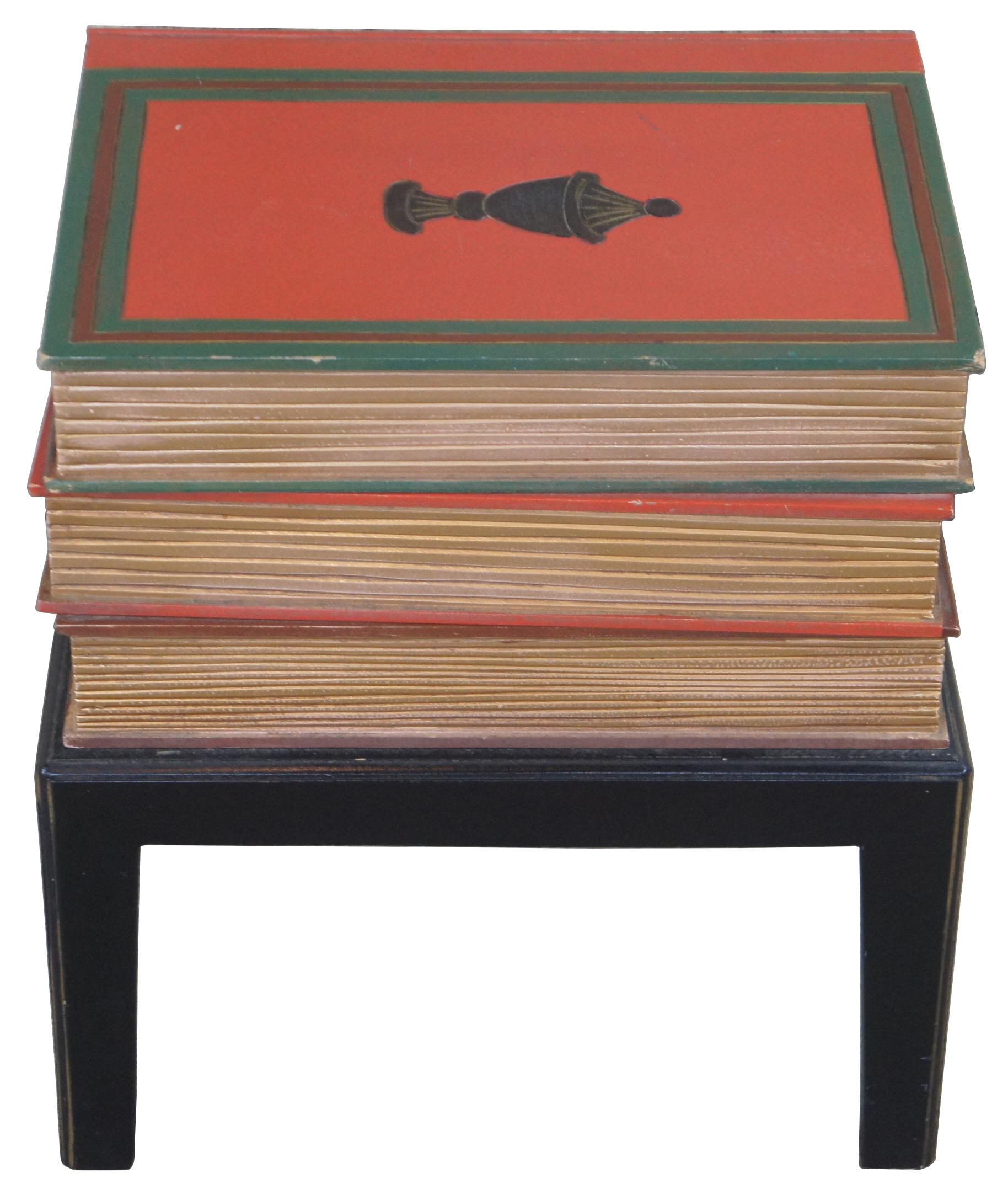 Vintage stacked book table. Features a trio of faux leather books with gold pages and black base. The top book has a neoclassical style urn motif.
   