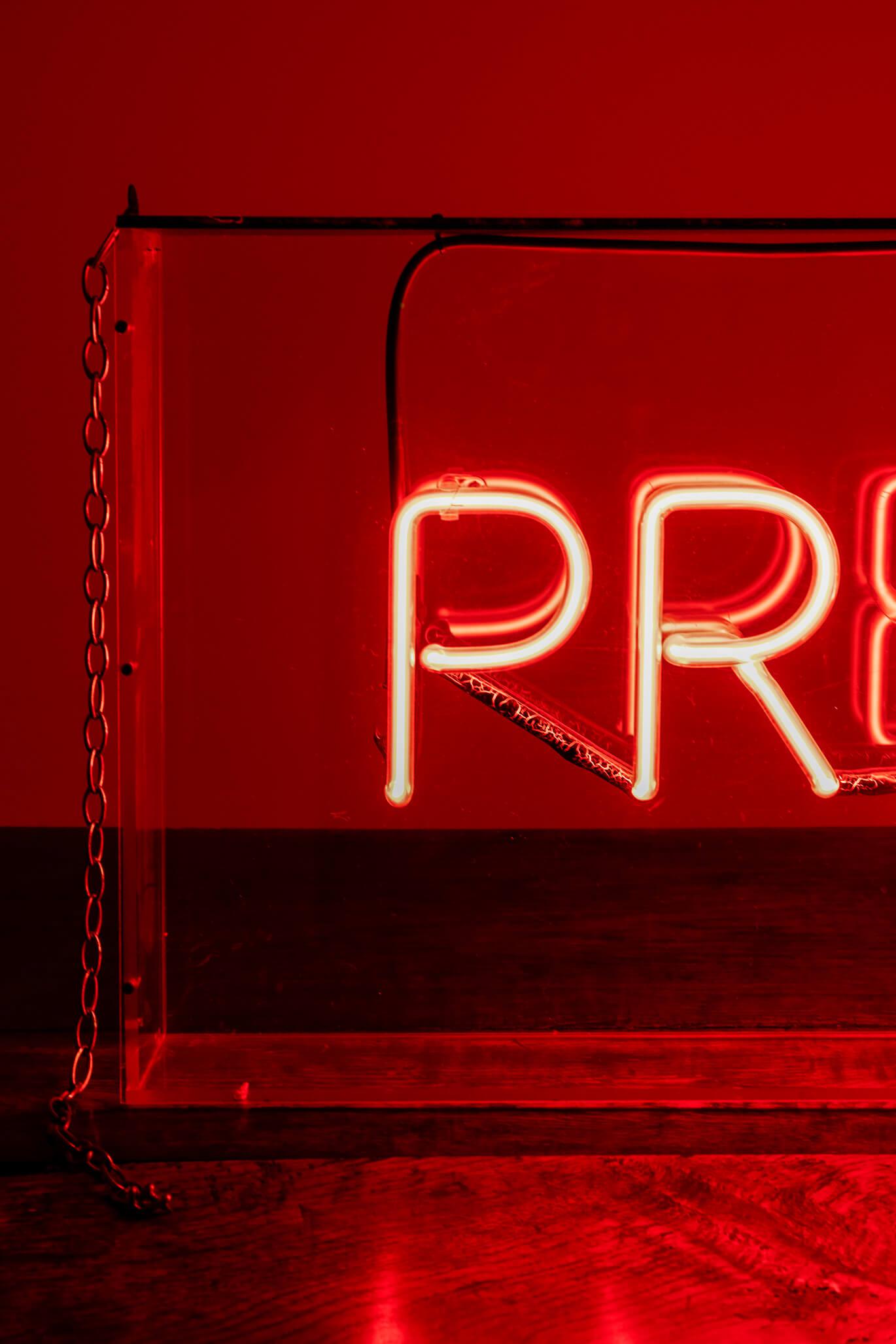 A commanding vintage neon chemist sign in a perspex box that reads ‘prescriptions’ once illuminated. 
Support chains are included on either side of the perspex box. Great size and presence. 
English, 20th century.

Additional information:
H 40