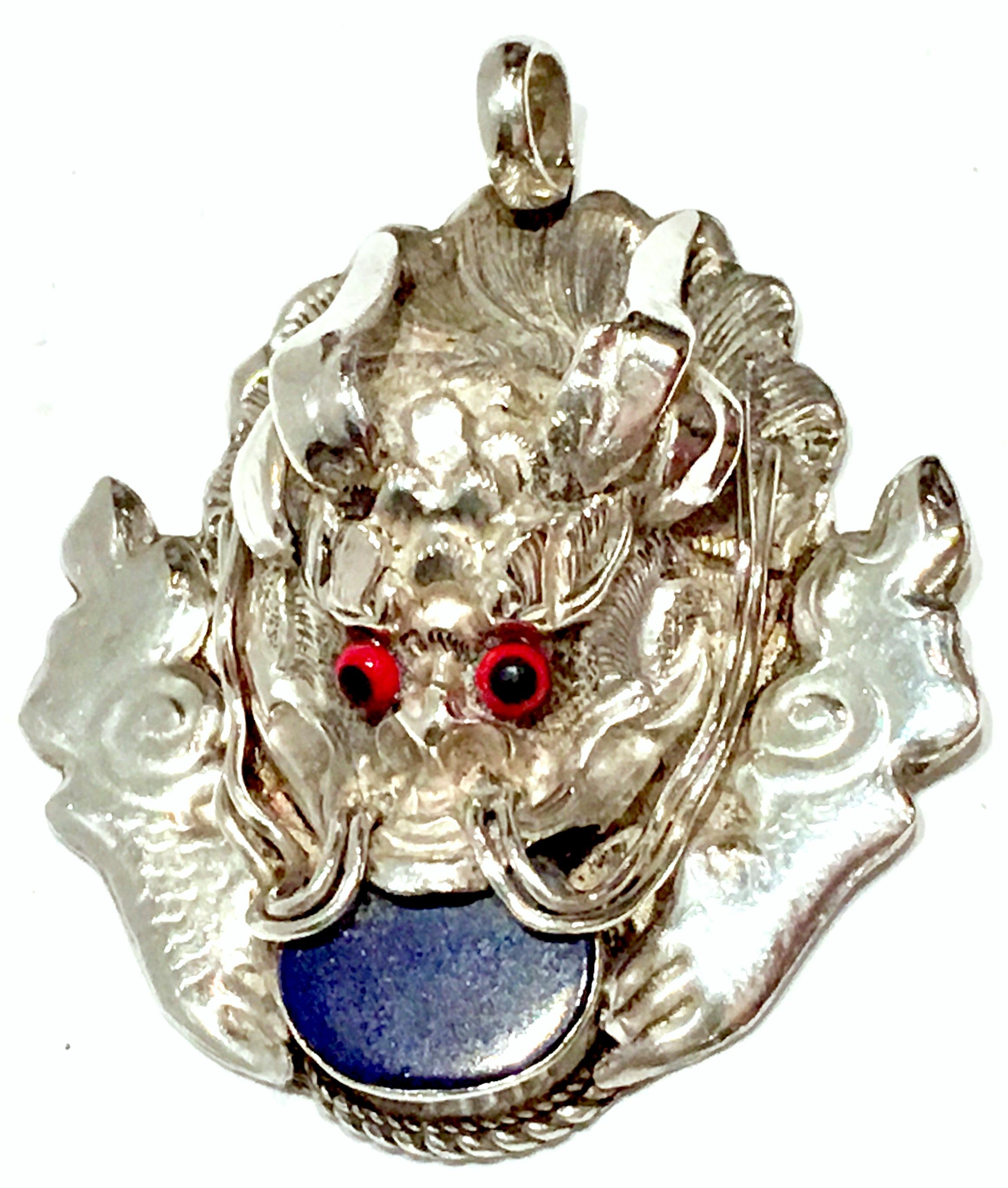 Rare sterling silver 925 dragon head with a polished Lapis Lazuli bezel set stone. Red eyes are made of resin. Signed on the backside, 925. Weight, 8 grams. Lapis stone measures approximately, .5