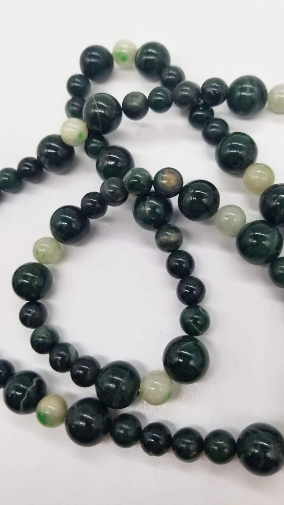 Mid-Century necklace of large Nephrite Jade 10mm beads and smaller Jadeite 8mm beaded necklace. Jade, revered for centuries, embodies both healing properties and stunning aesthetics. Believed to promote harmony and balance, it soothes the spirit
