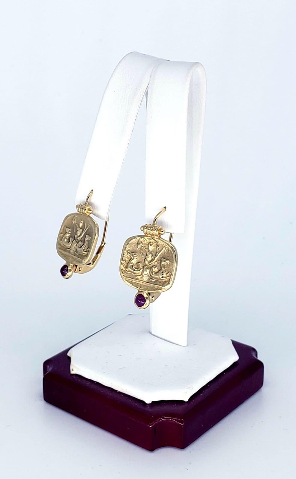 Vintage Neptune Ruby Gemstone Italy Drop Earrings. 

Give your look a real sea change of style with this pair of classically inspired drop earrings! Featuring images of the Roman god, Neptune, these handcrafted 14k yellow gold drops are an ornate
