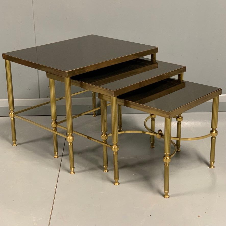 Fabulous quality lacquered nest of 3 brass and dark glass top tables, certainly in the style of Maison Jansen but not marked so cannot be sure.
All three tables are in super condition and have a very good heavy weight to them (rather than some of