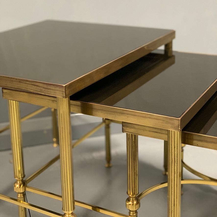 Hollywood Regency Vintage Nest of 3 Brass and Dark Glass Tables in the Style of Maison Jansen For Sale