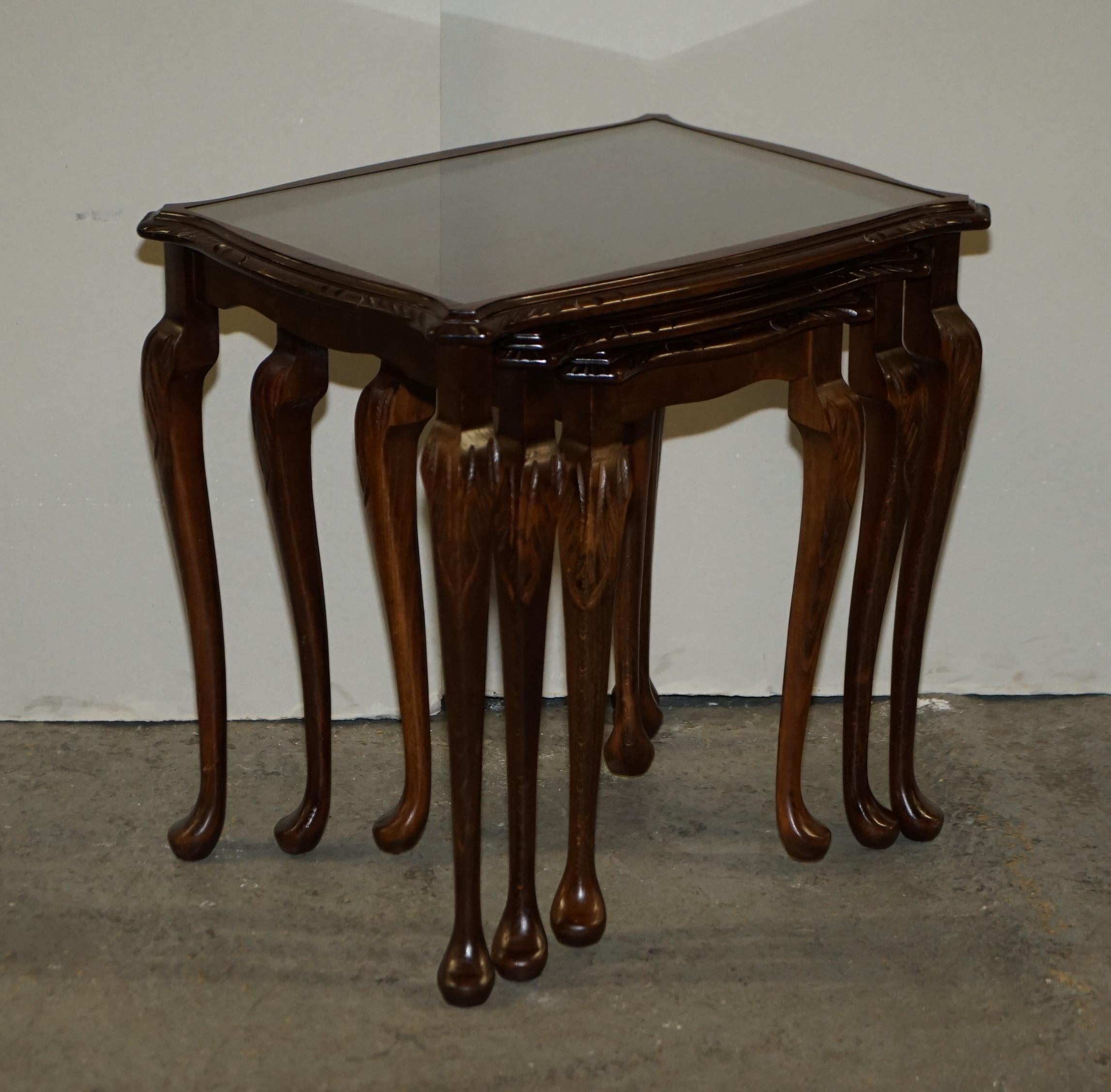 Here we have for sale a vintage nest of 3 stacking tables in solid mahogany with glass inset tops on tapered legs and carved detailing.

Overall, the tables are in good condition with a few minor signs of wear, they have been cleaned and polished