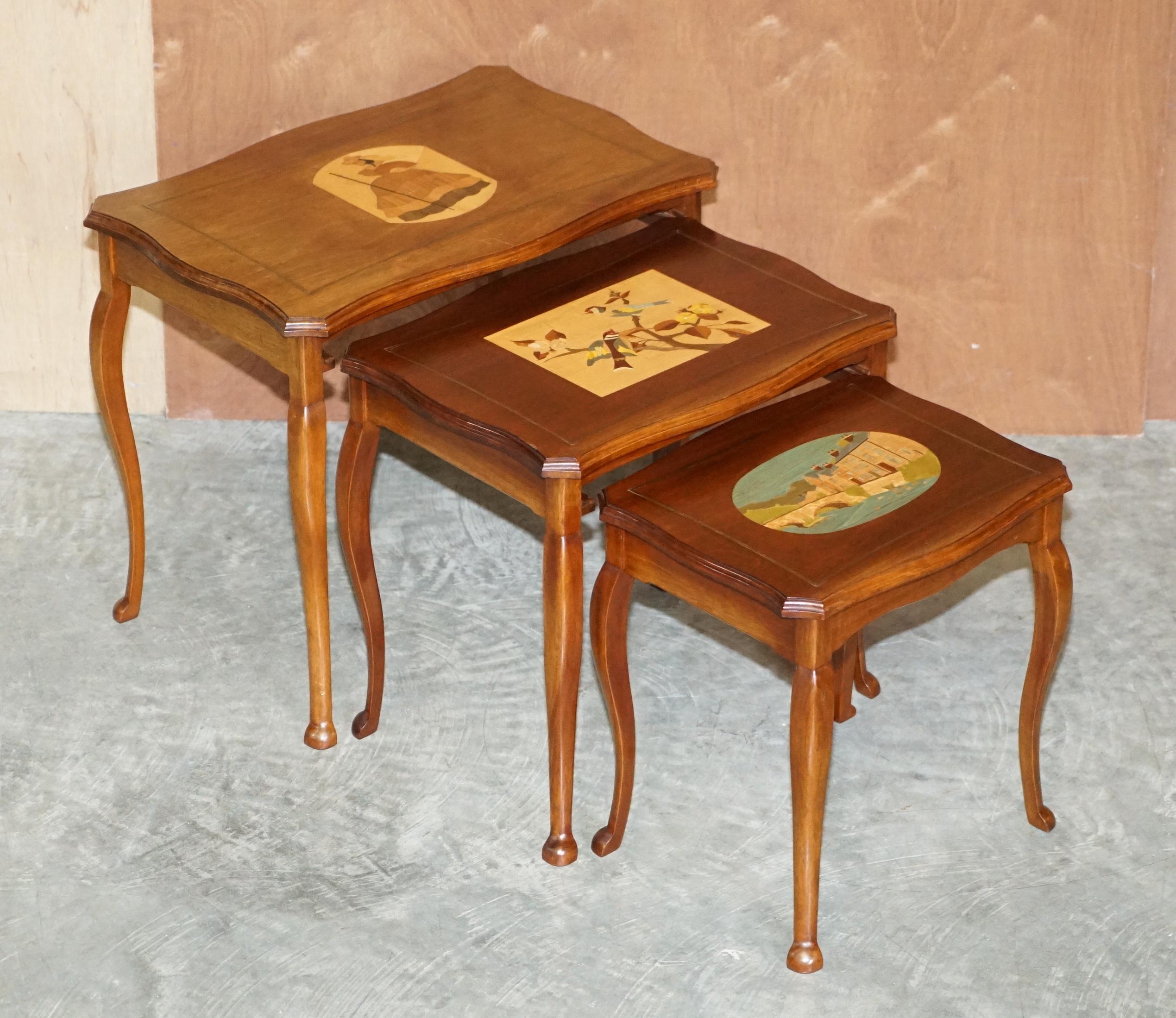 We are delighted to offer for sale this lovely nest of three tables with inlaid marquetry wood panels which have been hand painted

A very good looking and well made nest, each table depicts a different scene, the first one has a French lady in an
