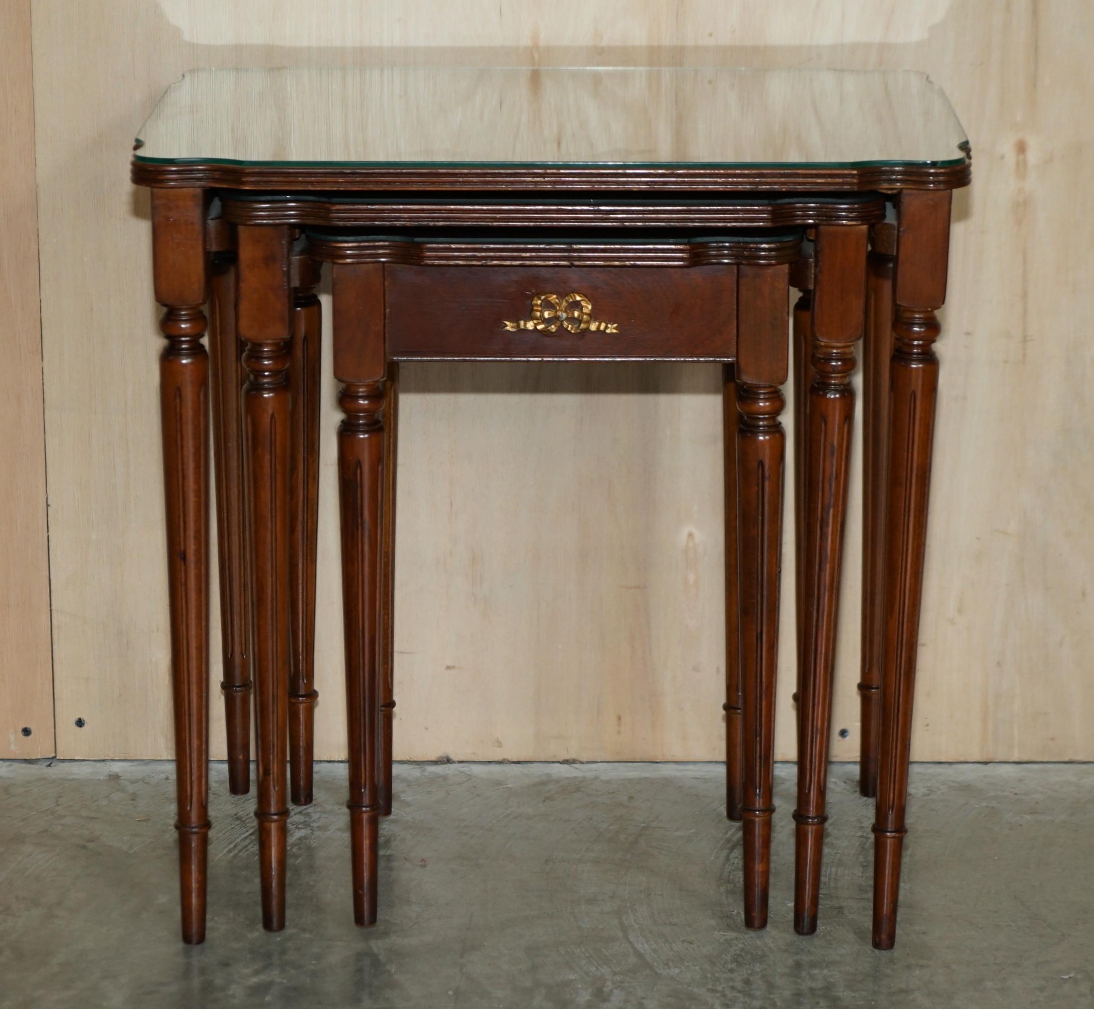 We are delighted to offer for sale this lovely nest of three French Empire tables which have flamed mahogany tops protected by glass inserts and finished with gilt brass mounts 

A very good looking and well made nest, the timber patina to the top