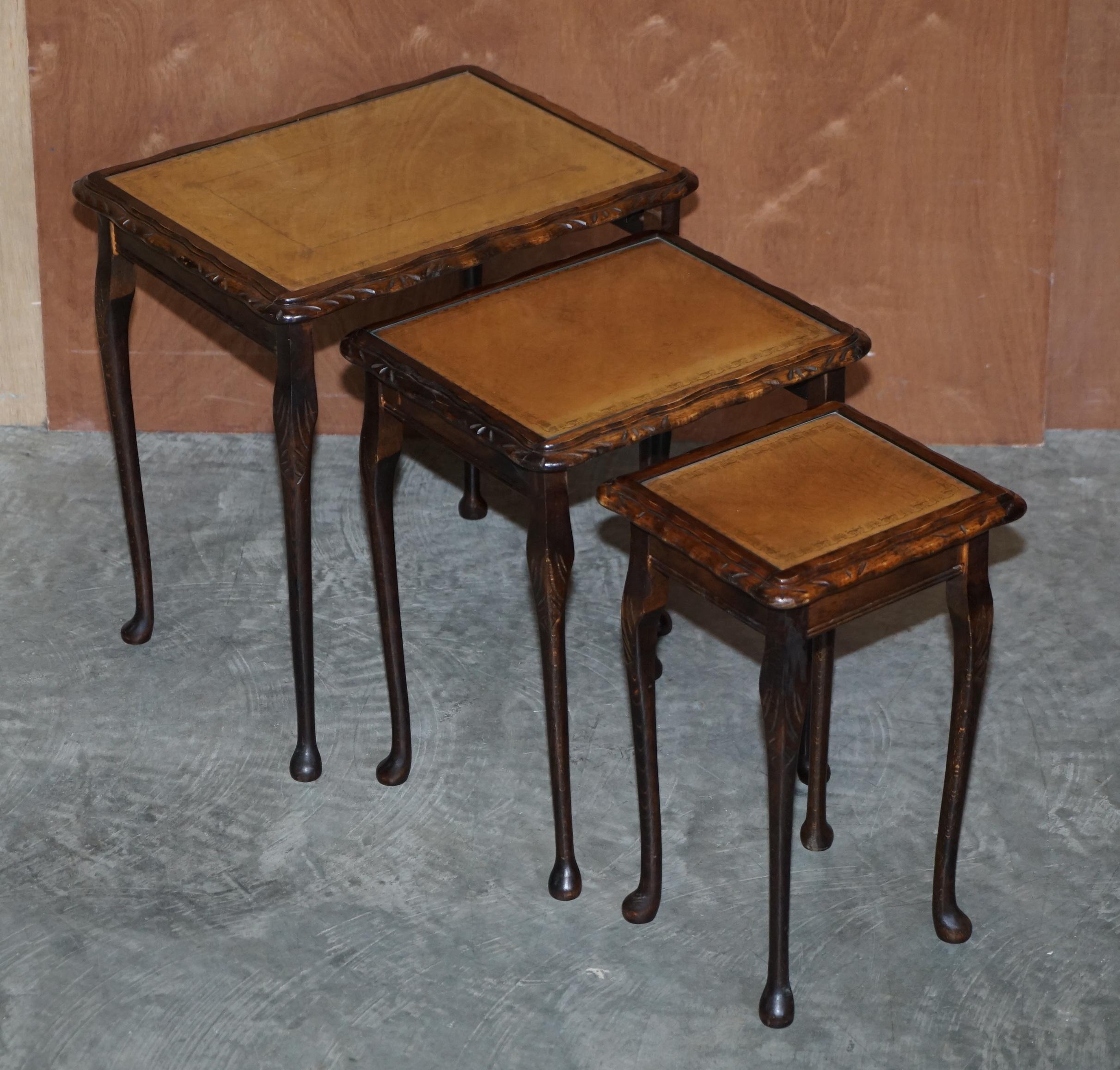 We are delighted to offer for sale this lovely nest of three tables which have gold leaf embossed tan brown leather tops that are protected by glass 

A very good looking and well made nest, each table has a tan leather top which looks very