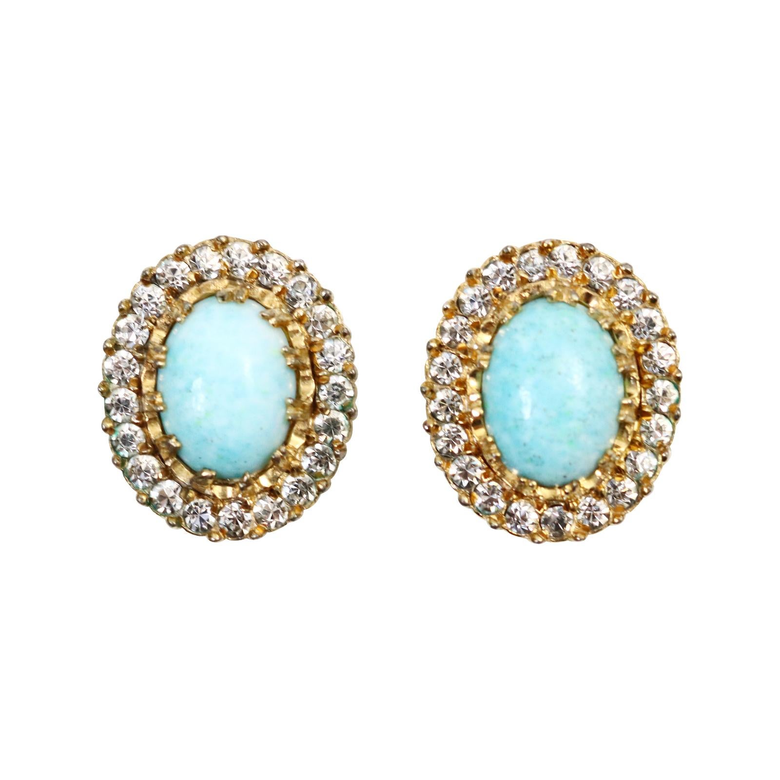 Vintage Nettie Rosenstein Faux Turquoise Diamante Earrings Circa 1960s. These are such well-made and well-designed earrings from the period.  They are set in gold tone with a diamante prong set that encircles the entire earring, creating a more