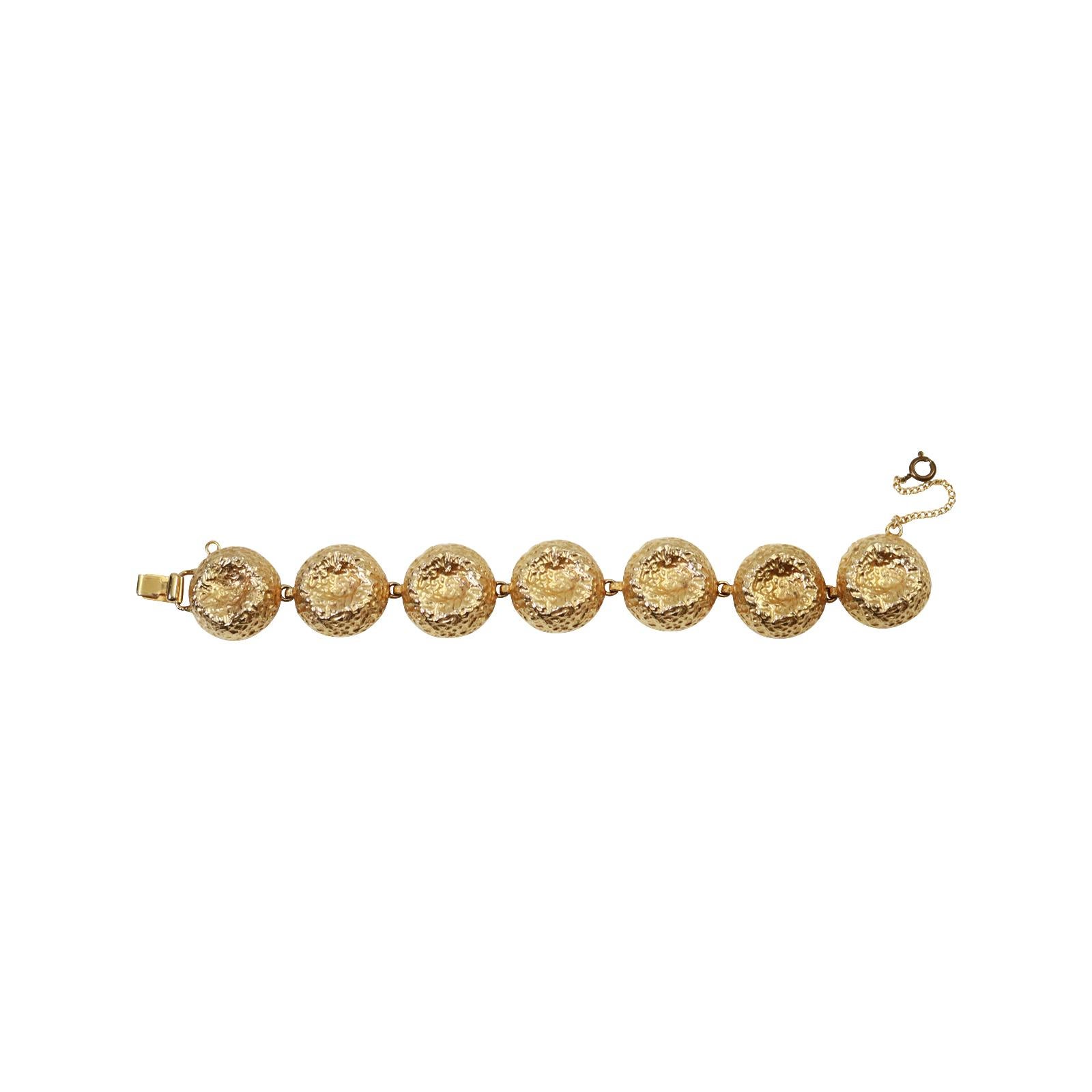 Vintage Nettie Rosenstein Gold Tone Bracelet Circa 1960s.Vintage Nettie Rosenstein Gold  Bracelet with Gold Domed  Discs.  The Back features beautiful Design that only the 1960's could provide. This bracelet is so stunning.  The inside of the