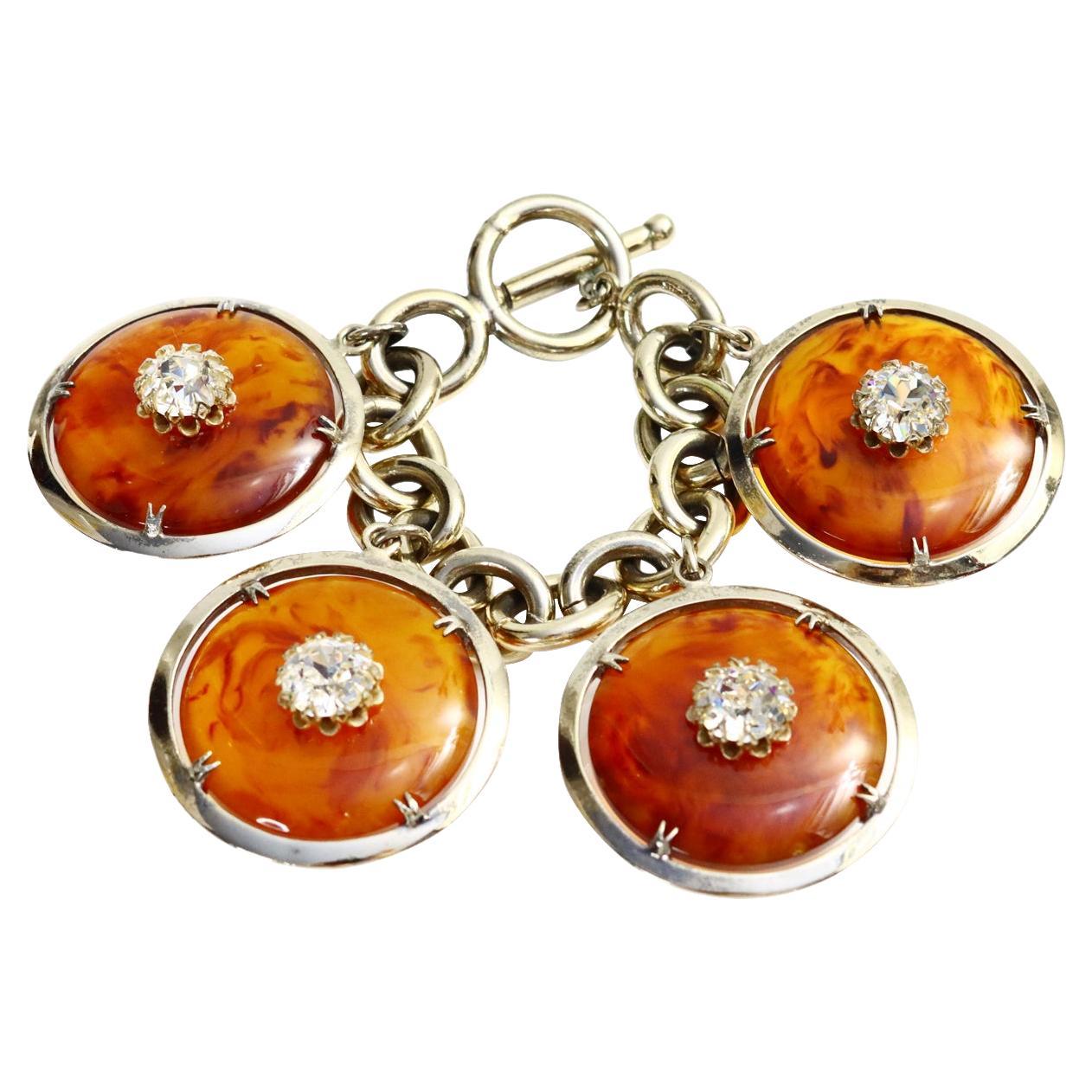 Vintage Nettie Rosenstein Antique Gold/Silver Dangling Faux Tortoise Bracelet Circa 1960s.  The wash is between a Silver and Washed out Gold.  The pieces of Faux Tortoise have a Crystal on each one. The Clasp is a toggle clasp.  It looks so chic on.