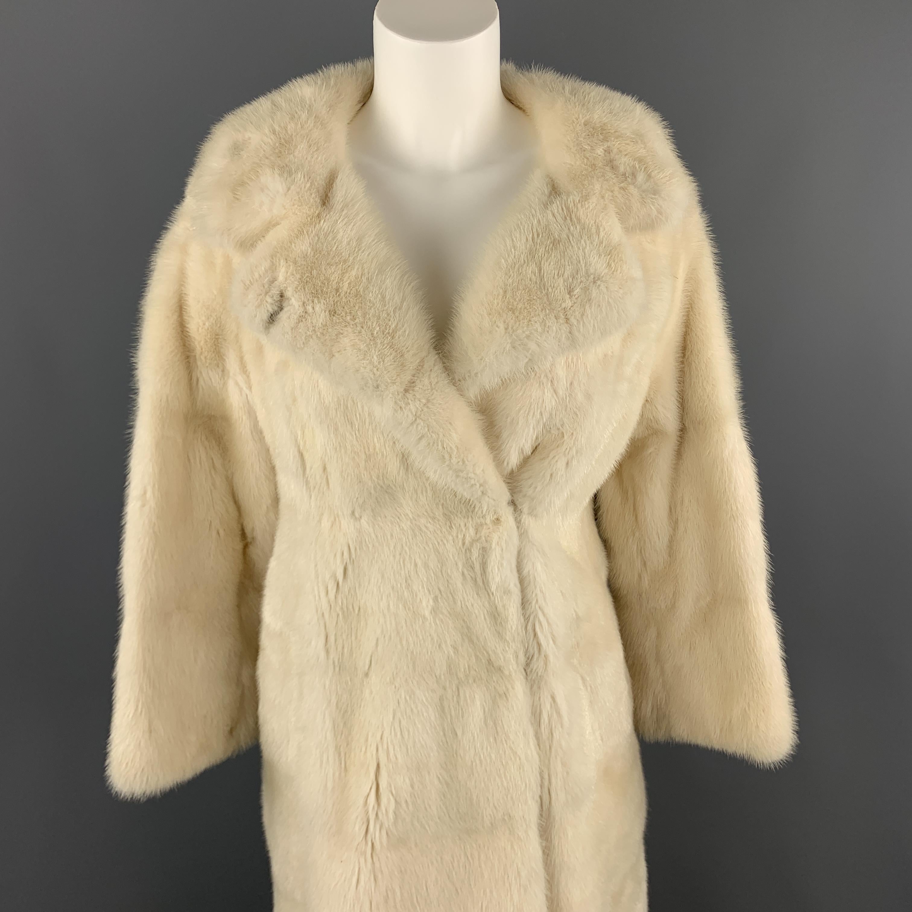 Vintage NEUSTETERS fur coat comes in creamy off white mink with a collared neckline, slit pockets, and double breasted hidden hook eye closures. Made in USA. 

Very Good Pre-Owned Condition.
Marked: M

Measurements:

Shoulder: 18 in.
Bust: 38