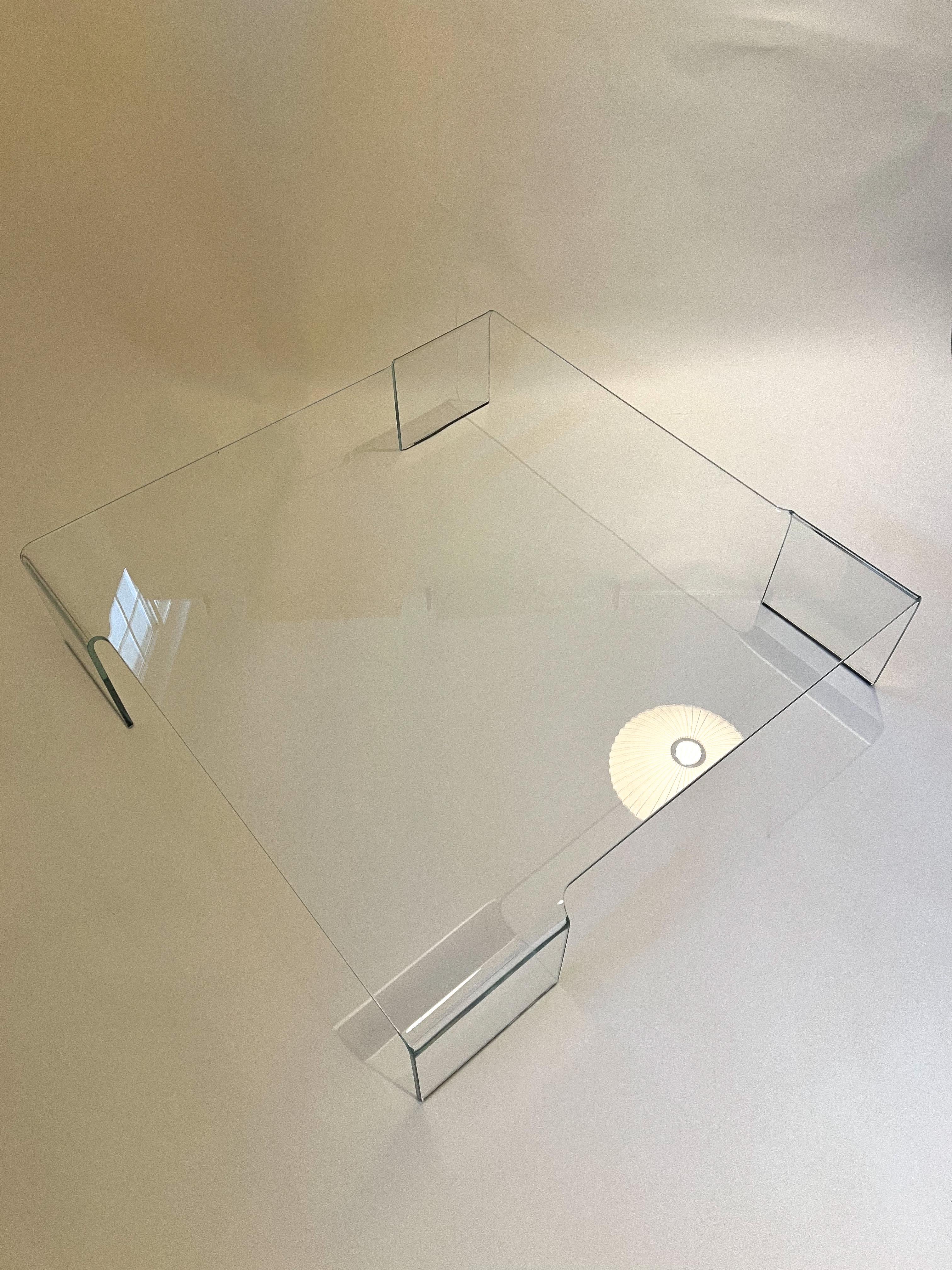 Authentic vintage monolithic coffee table made of a 1/2-inch thick continuous piece of glass that’s curves at the legs for a “waterfall” effect. Incredible statement piece. Designed by Rodolfo Dordoni for FIAM Italia.