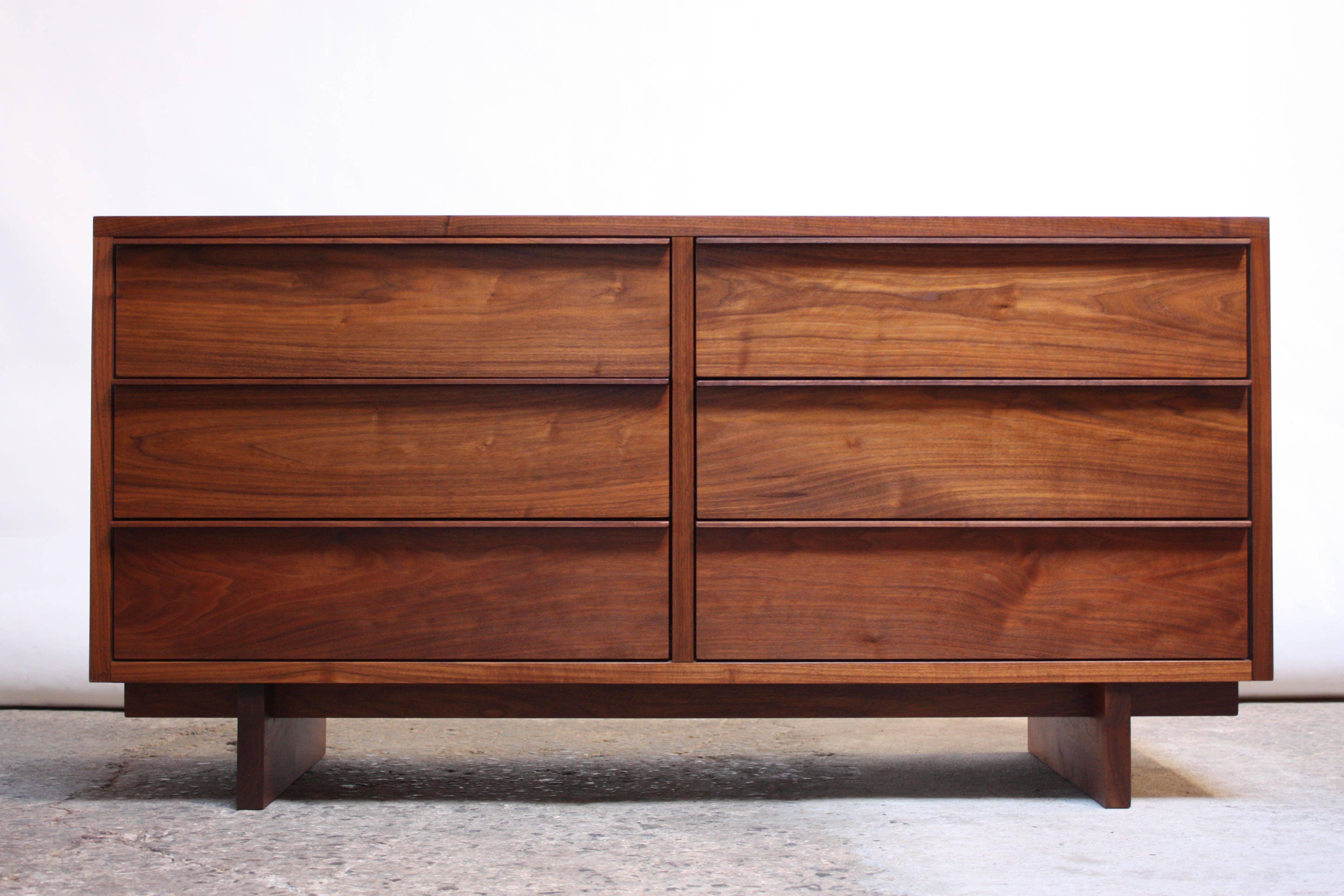 Solid walnut six-drawer chest with linear sculptural pulls designed and manufactured on custom order by Vermont Furniture Designs, circa early 1980s. The chest is mounted to two solid walnut block bases, and there are two solid walnut 'bars' (one in