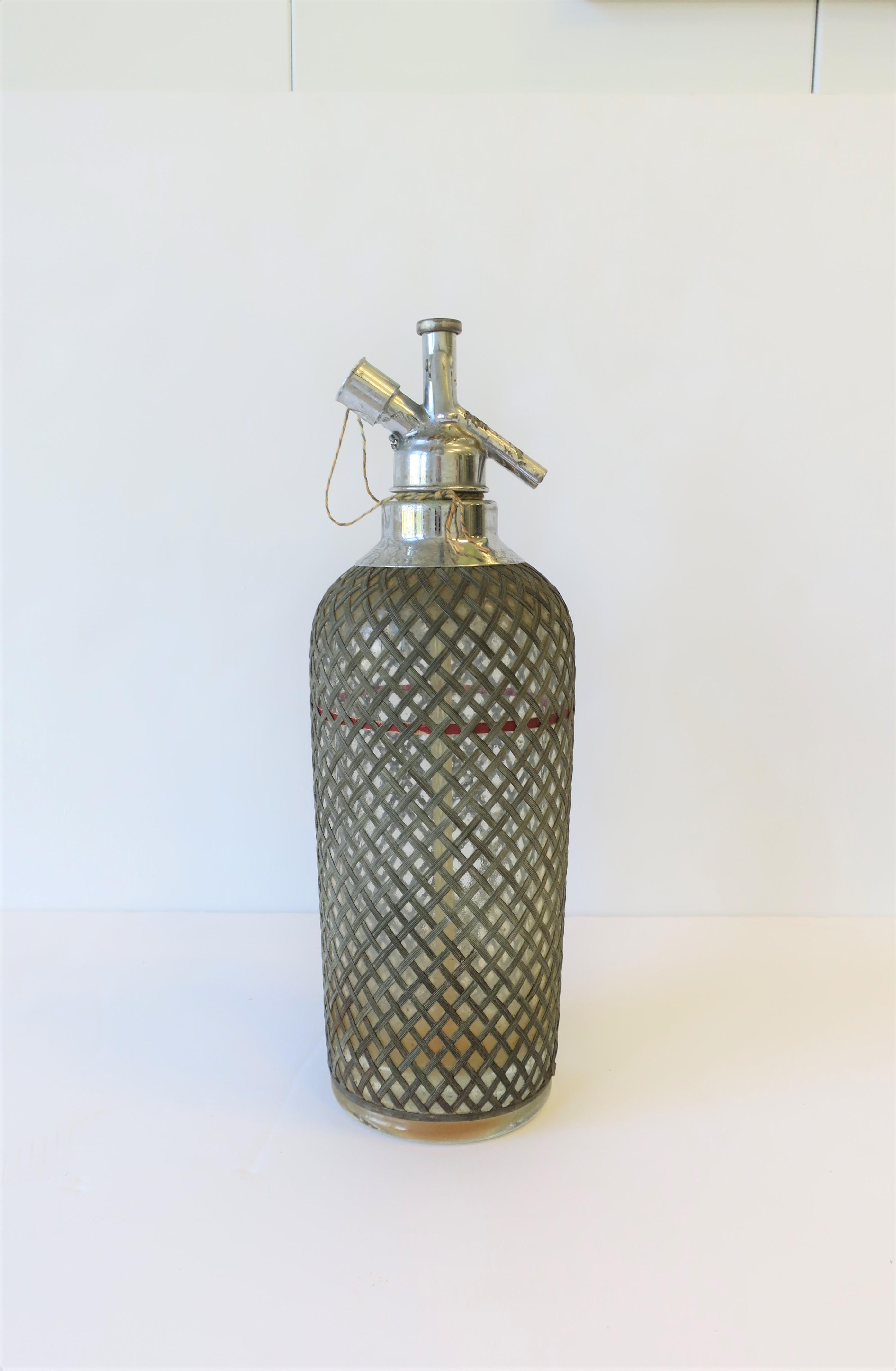An early 20th century rare glass 'syphon' seltzer soda water bottle with metal wicker wire mesh protection. Bottle was made for New York soda company 'Sparklets' New York, as show in images #10 and 11. Bottle is marked on bottom, 