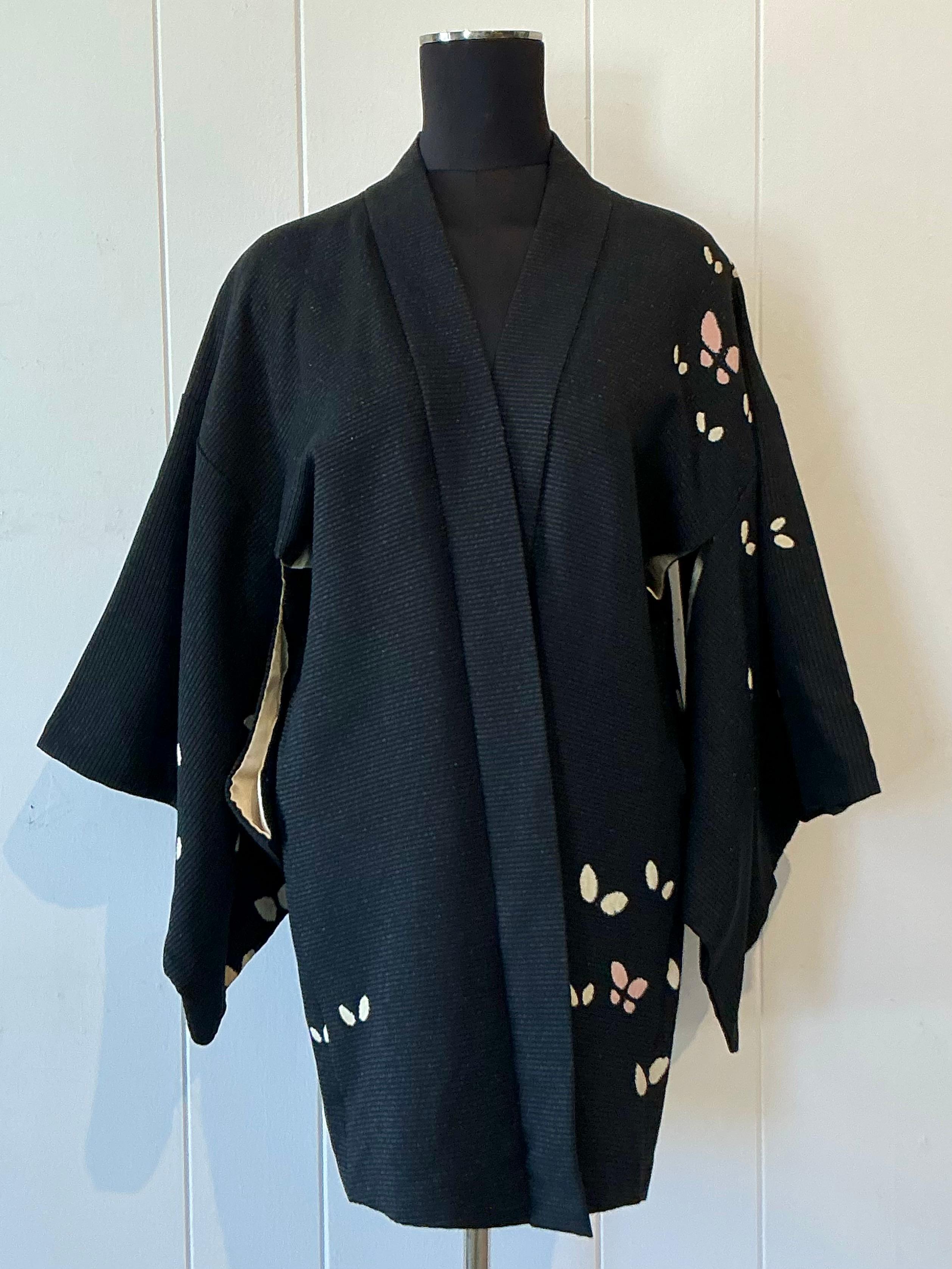 This vintage Nfuji kimono is a striking piece of wearable art that reflects the elegance and cultural richness of traditional Japanese design. Crafted with meticulous attention to detail, it features intricate patterns—possibly floral, geometric, or