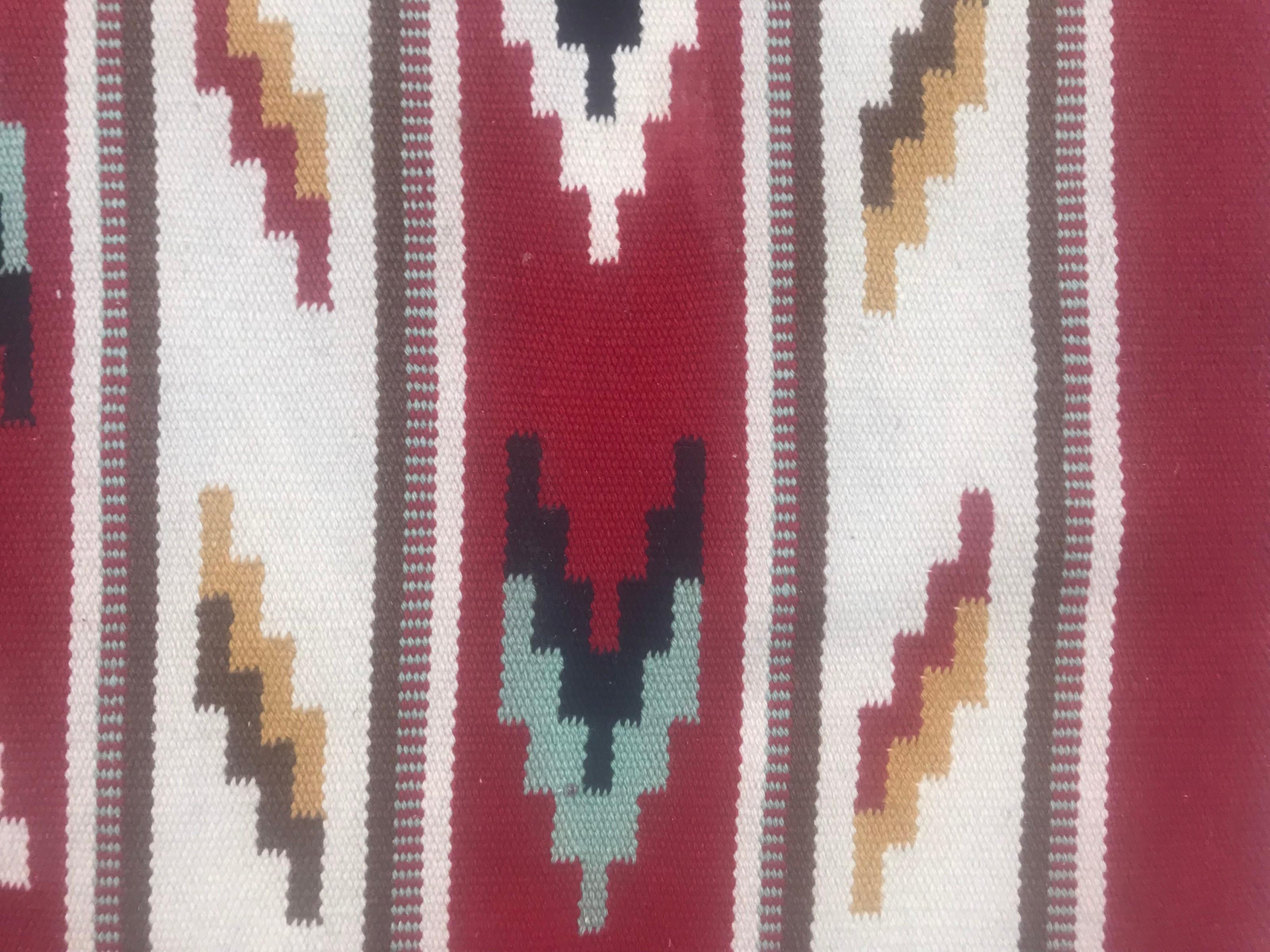 Stunning 20th-century flat-woven Scandinavian rug featuring a captivating geometrical design and vibrant colors including red, blue, orange, grey, and black. Meticulously handwoven with wool on a cotton foundation. A timeless piece that adds beauty