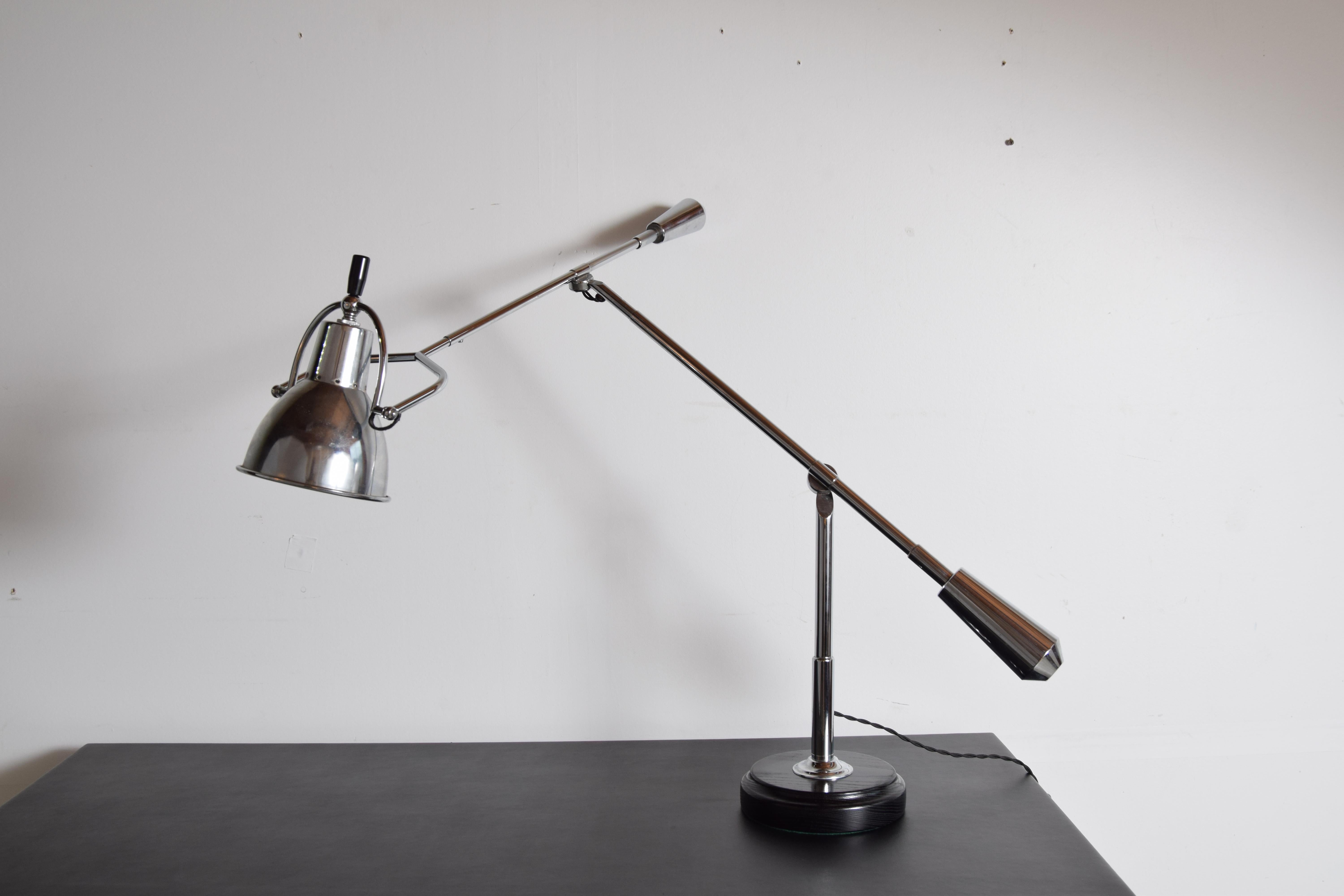 Large desk or table lamp designed by Édouard-Wilfred Buquet, France, 1927. Nickel-plated brass arms with an aluminum shade, resting on a round ebonized and lacquered oak base. This production most likely, 1970s. An incredibly well designed, well