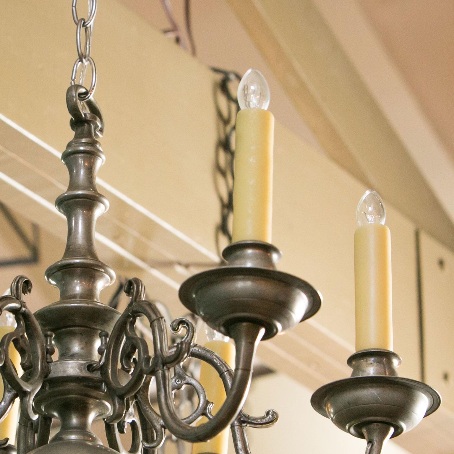 Georgian style classic chandelier with six arms. This nickel-on-bronze chandelier has a beautiful patina that has a bit of a pewter color, but is much harder and heavier than pewter. This vintage Flemish-style light is a true Classic that has a