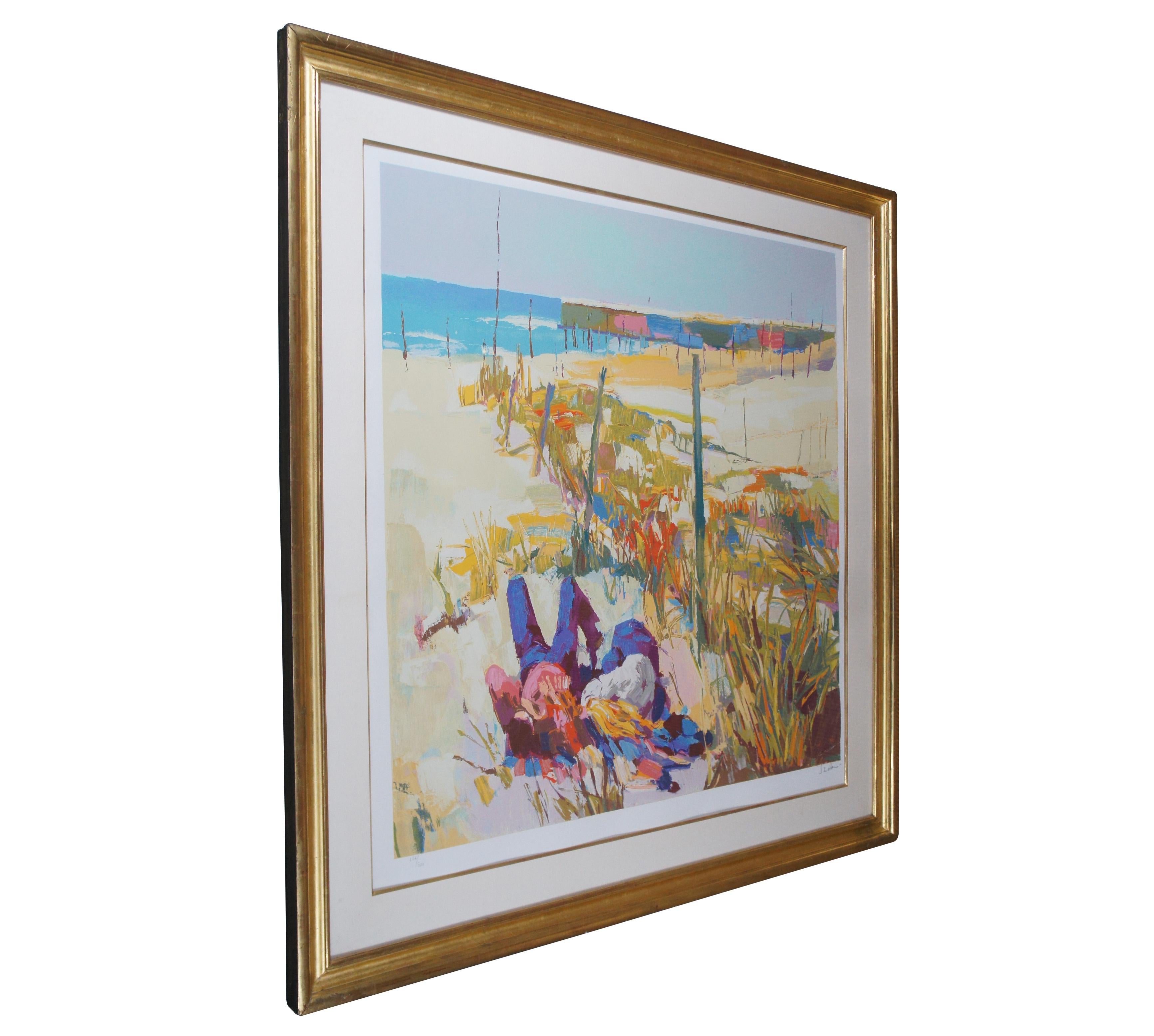 Vintage 1970s limited edition serigraph print by Nicola Simbari, showing a figure of a couple laying at the beach with boats and water in the background; pencil signed and numbered 126/300. “Nicola Simbari is a painter of semi-abstract impressionist