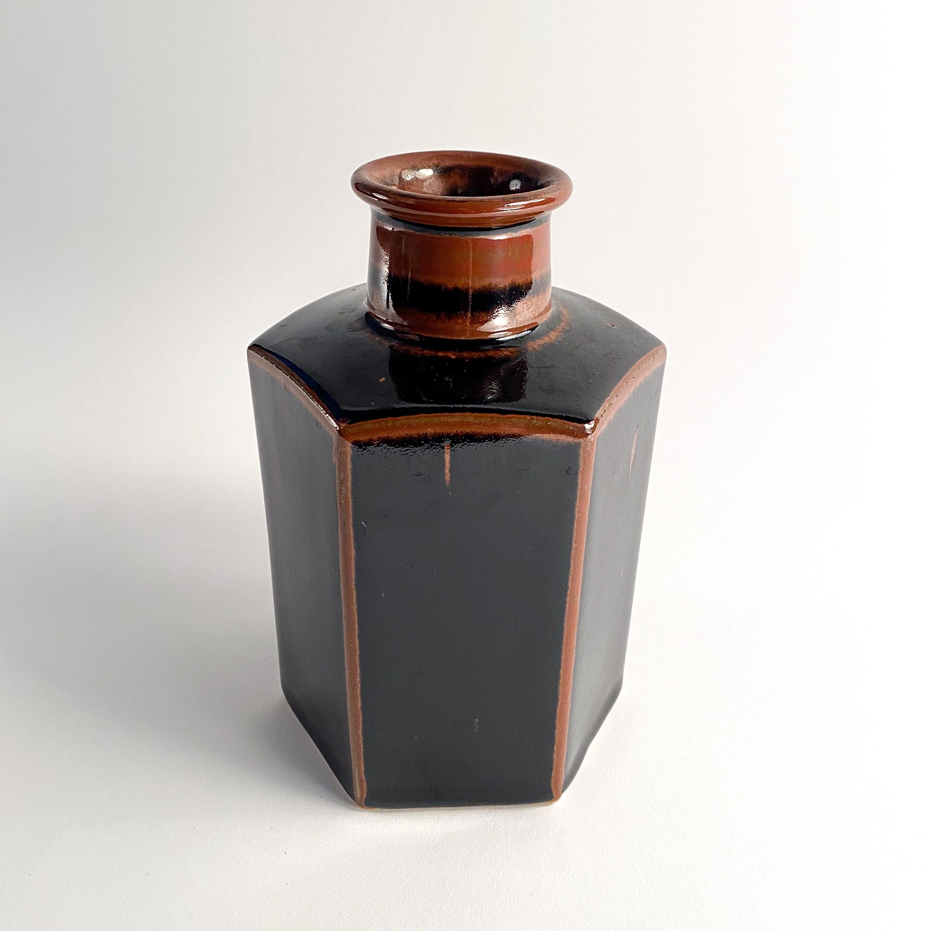 Hexagonal vase by Dansk. Designed by Niels Refsgaard for Dansk. Black hexagon stoneware vase glaze with redish brown glaze accent. marked on underside