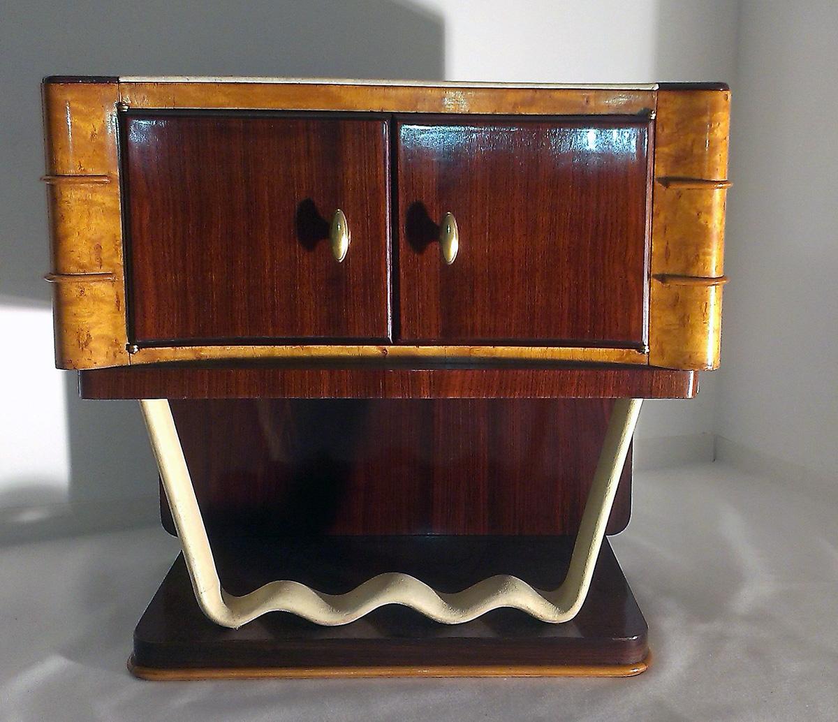 A pair of nightstands made of different woods and colored leather, marked 