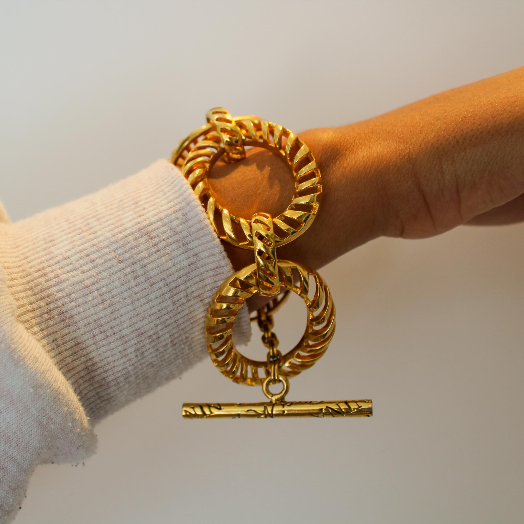 Nina Ricci Vintage 1980s Bracelet

A beautiful statement link bracelet from legendary French designer, Nina Ricci. Made in France in the late 80s, this incredible bracelet is crafted from an open work gold plated metal and engraved with Nina Ricci
