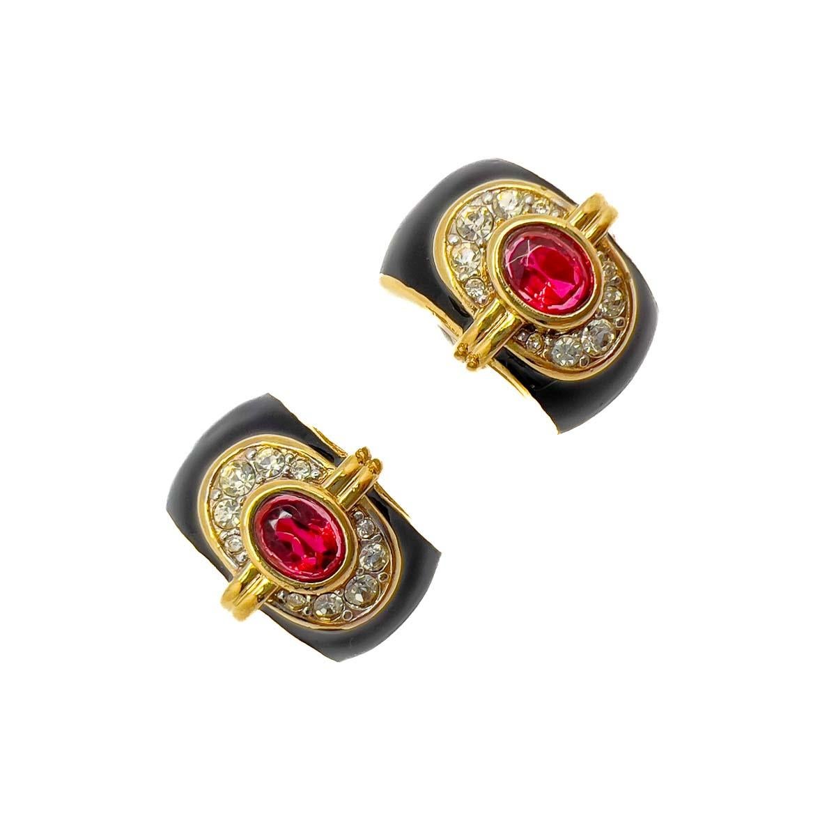 A sublime pair of Vintage Nina Ricci Art eco Earrings. Designed in a huggie style with a glorious and effortlessly timeless Art Deco design. The opulent black enamelling contrasting to perfection with the central oval ruby crystal. Finished with a
