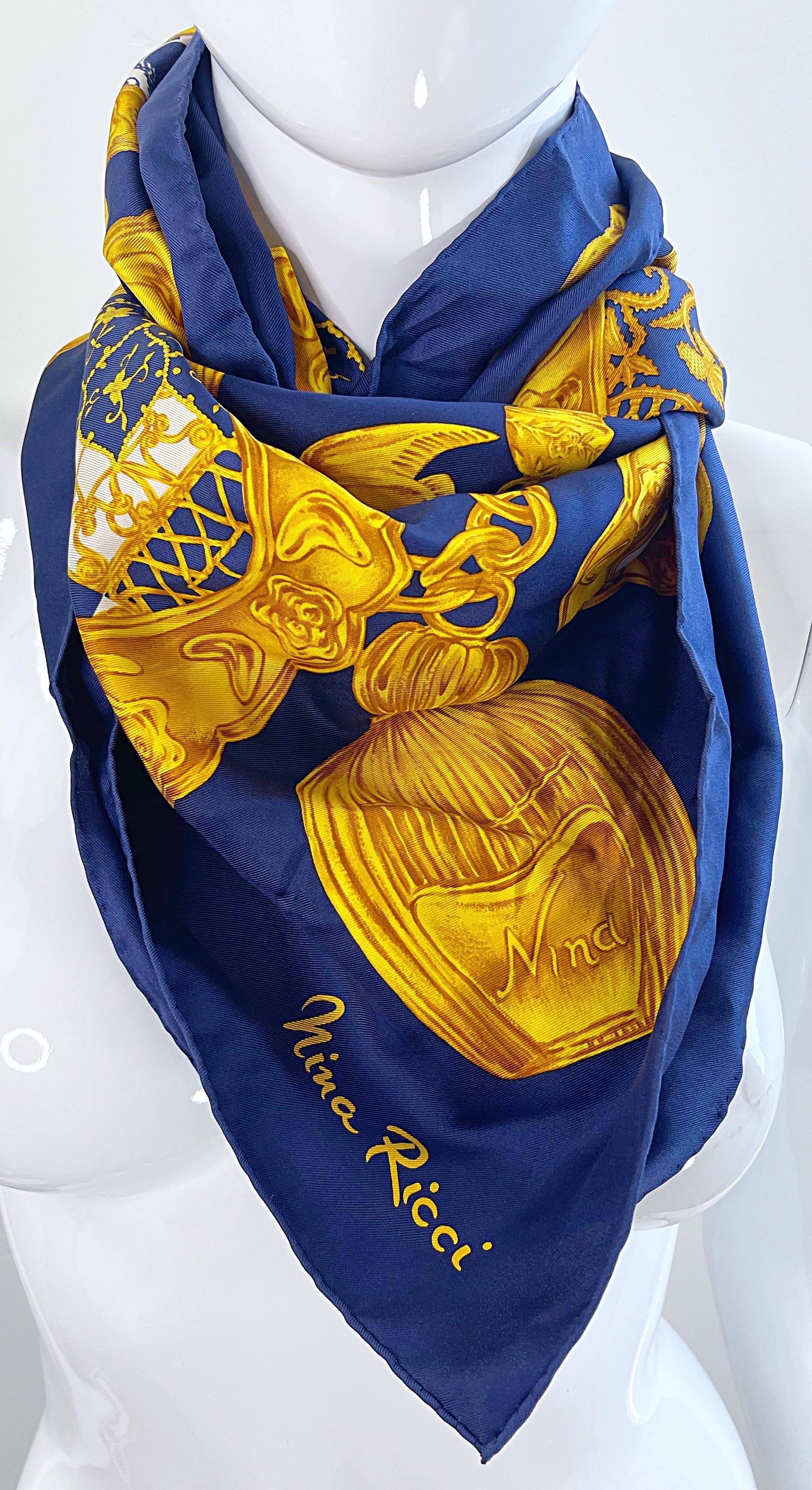 Chic vintage NINA RICCI navy blue, gold and white novelty charm bracelet print large silk scarf. Can be worn a number of ways. Draped over the shoulders, as a had scarf, or wrapped around the neck. The perfect accessory that can instantly bring any