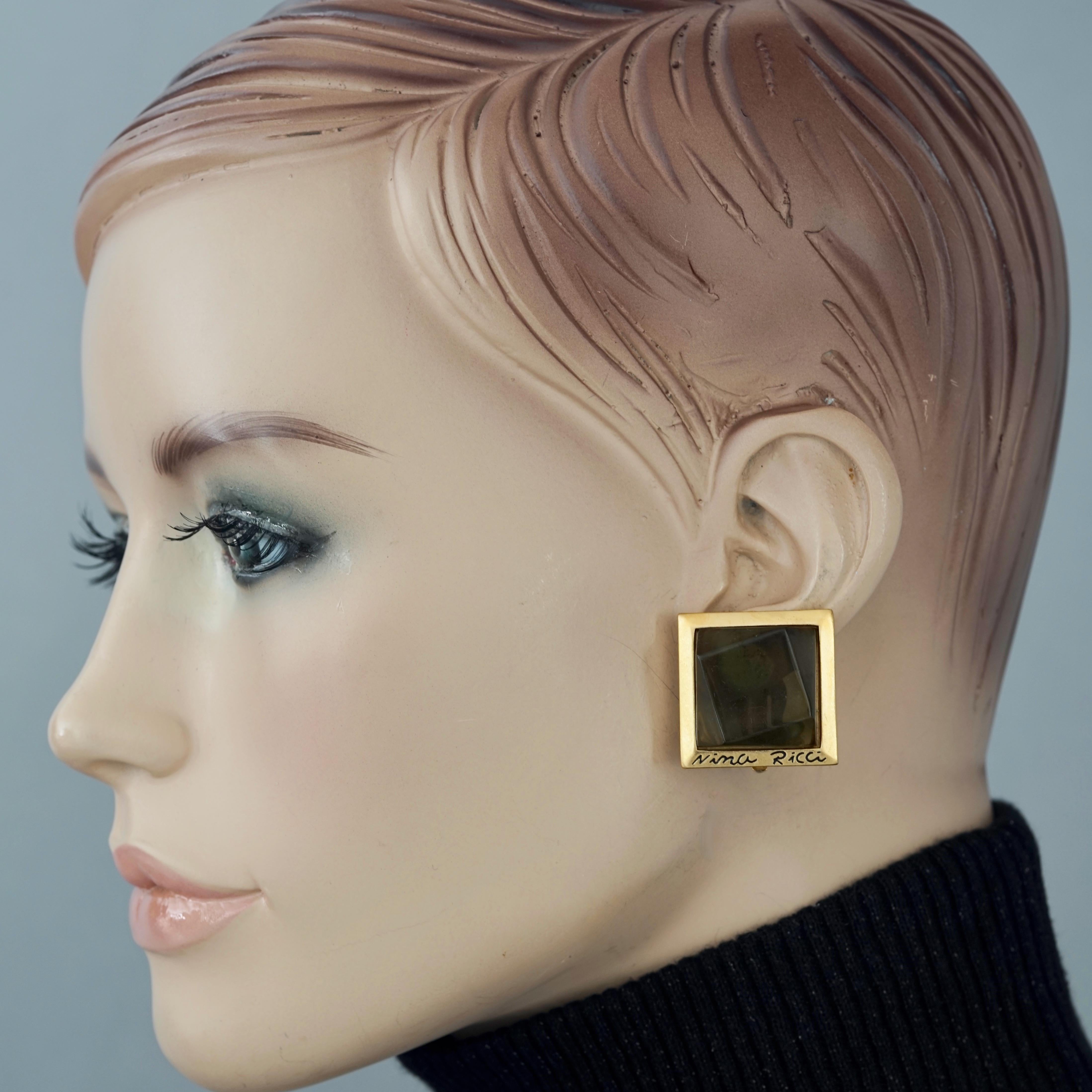Vintage NINA RICCI Geometric Square Earrings

Measurements:
Height: 1.02 inches (2.6 cm)
Width: 1.02 inches (2.6 cm)
Weight per Earring: 11 grams

Features:
- 100% Authentic NINA RICCI.
- Geometric square earrings in olive green resin.
- Engraved