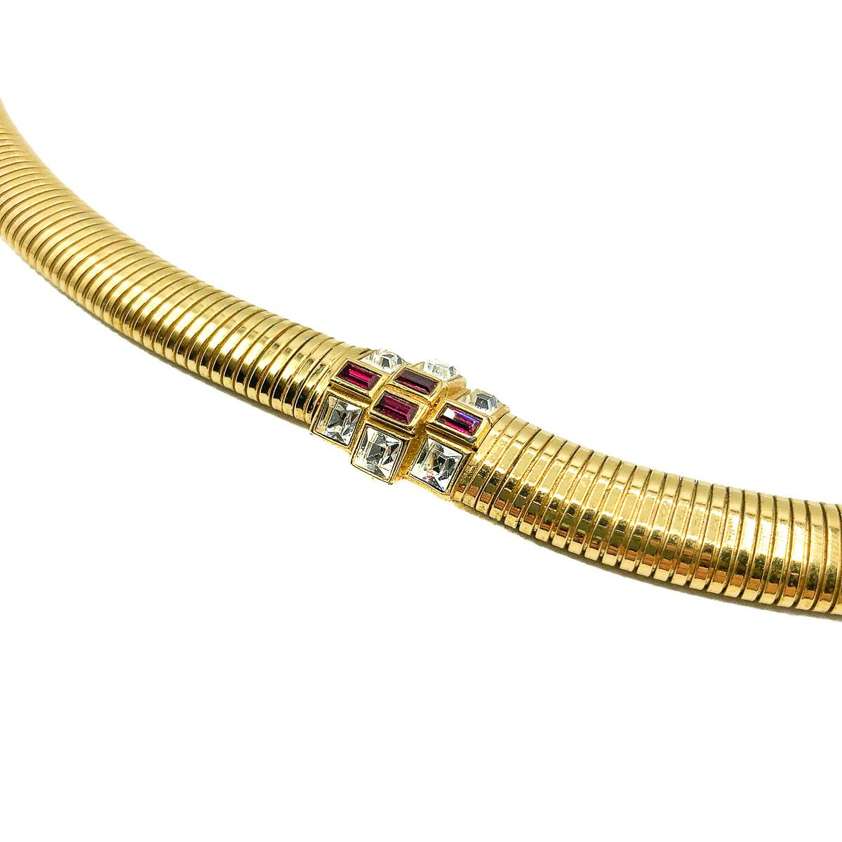 A totally timeless and oh so glamorous Vintage Nina Ricci Ruby Collar. Crafted in high quality gold plated metal and set with fancy cut crystal stones emulating ruby and diamond. Omega style collar. In very good vintage condition. 39cms. Signed. A
