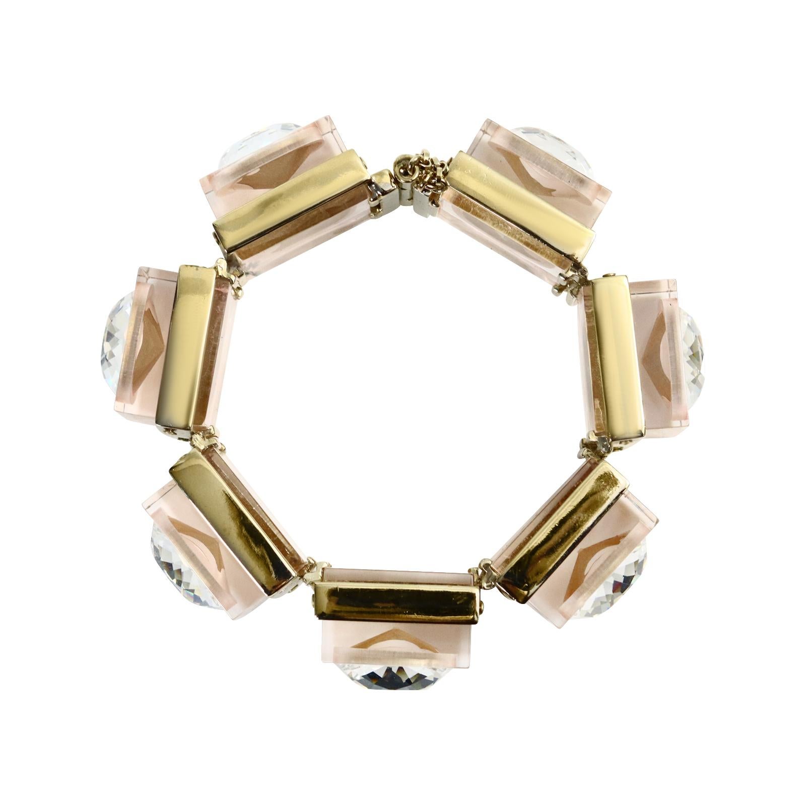 Vintage Nina Ricci Lucite Metal and Crystal Link Bracelet. Square Links set in gold  tone metal and then in lucite resin and then embedded with a large faceted cut Crystal form this bracelet.  It has a slightly smoky beige  color.  Closes with a pin