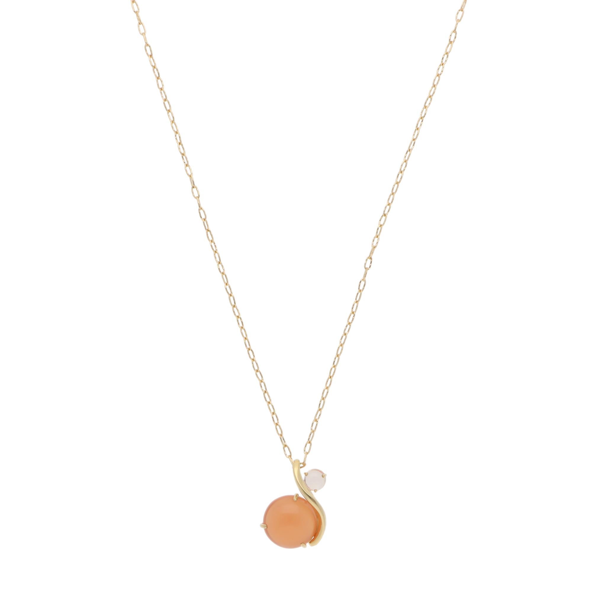 A beautiful vintage Nina Ricci moonstone and rose quartz pendant necklace set in 18k yellow gold.

The necklace features a large cabochon moonstone and a smaller cabochon rose quartz. They are securely set in three-prong open gallery settings and