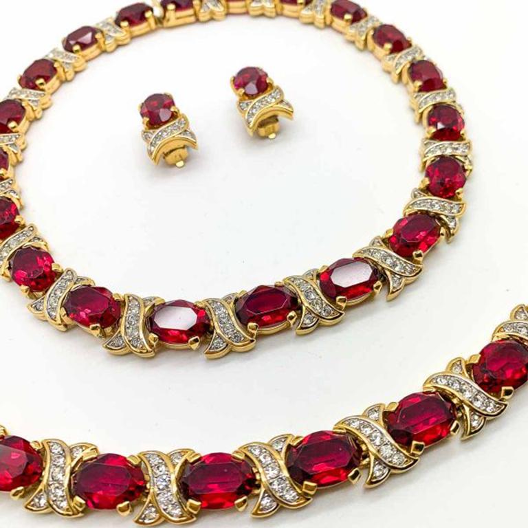 A truly glamorous Vintage Nina Ricci Ruby Necklace Set. One of the best examples we have seen from Ricci. Still intact as a full parure offering a necklace, bracelet and earrings. An increasingly rare find. Featuring perfectly colored, large, oval
