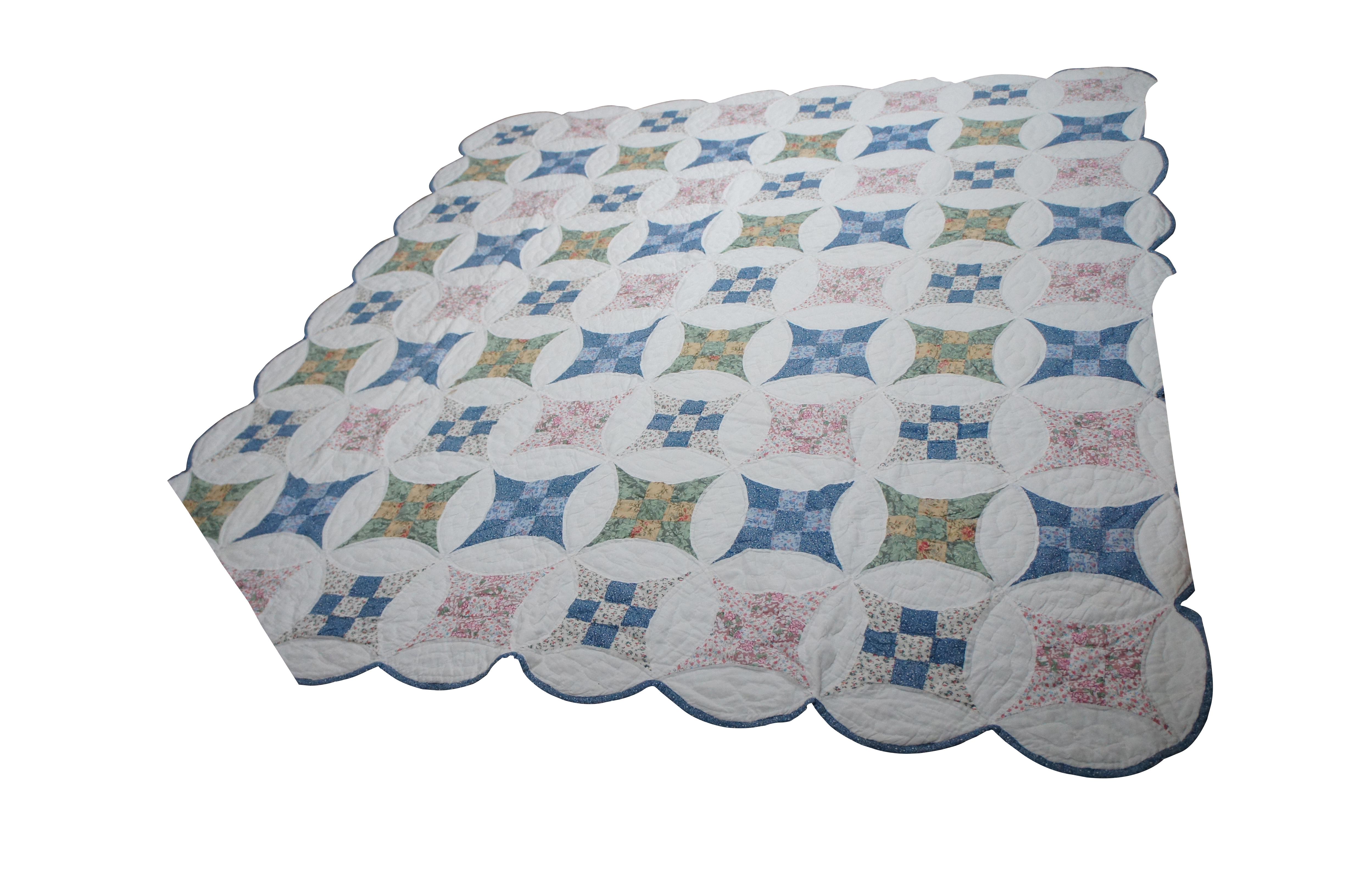 Vintage hand stitched quilt, blanket or bedspread featuring the Glorified or Improved Nine Patch geometric scalloped design with circles, squares and floral motifs.  Full to queen size.

The first known Nine Patch Quilts were made at the beginning