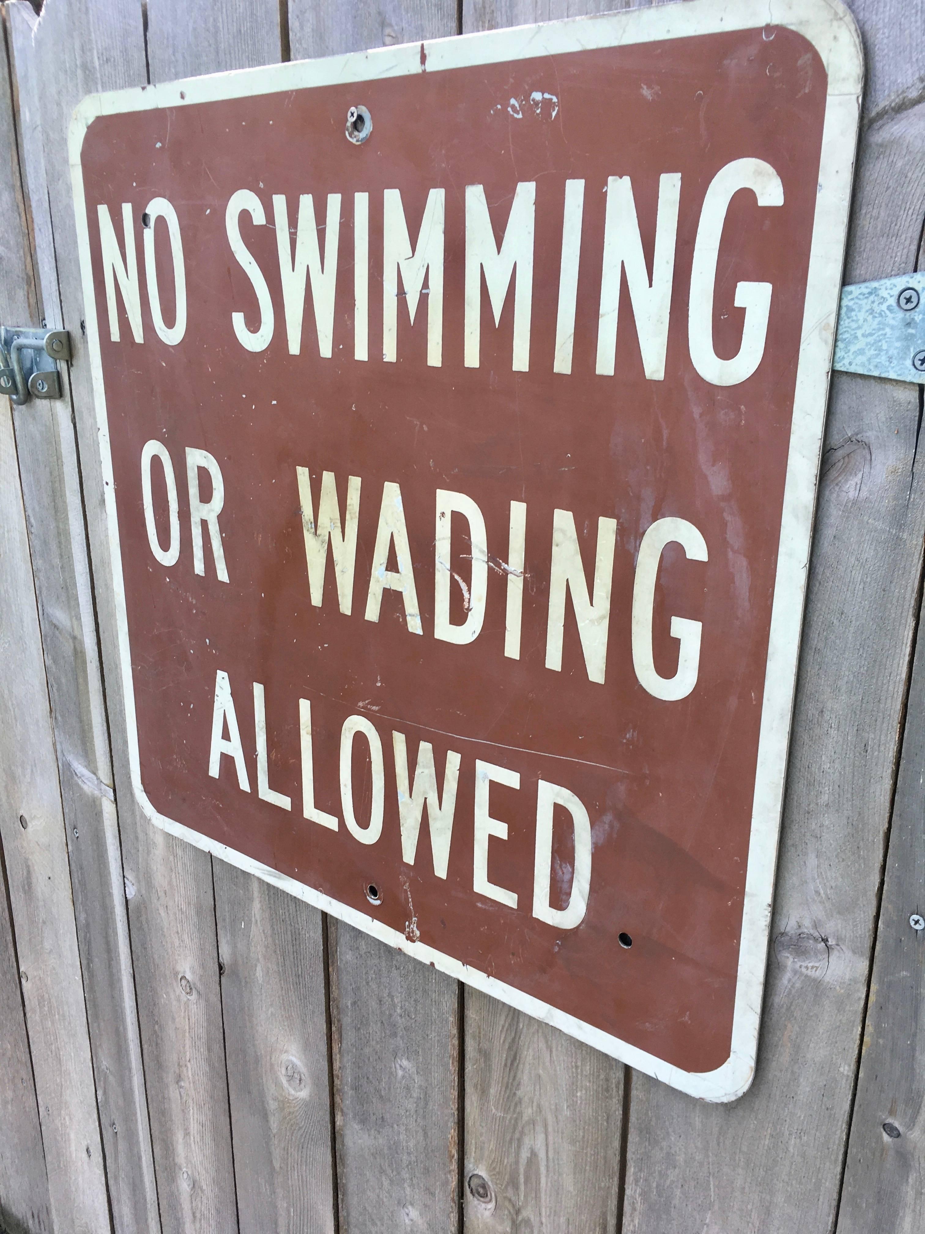 Vintage no swimming or wading allowed sign. Metal sign. Great patina. Cool wall art or pool sign.