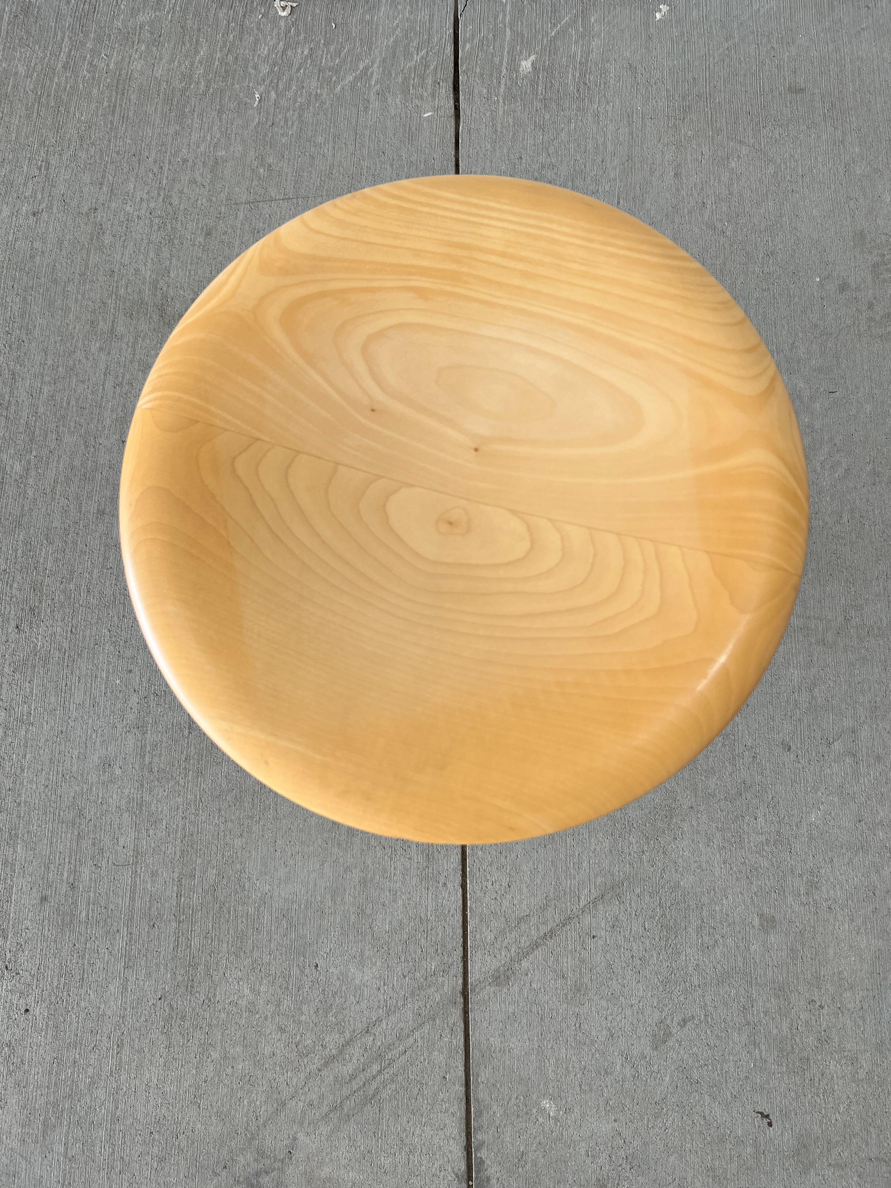 Isamu Noguchi iconic rocking stool in blond wood with polished chrome accents, 14” diameter x 17”high. Vitra production.