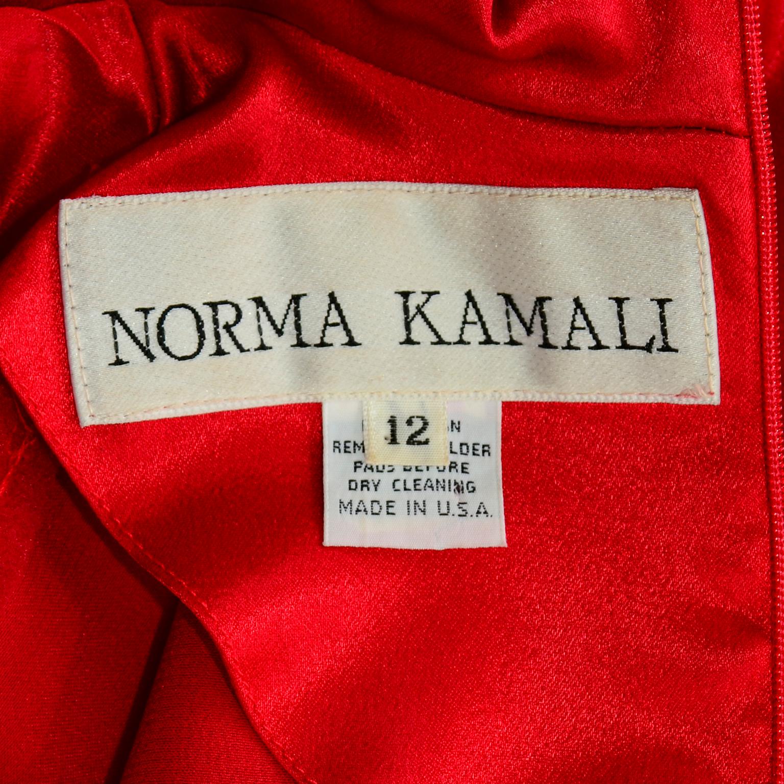 We adore vintage Norma Kamali pieces and this red satin jumpsuit is simply stunning! This Norma Kamali jumpsuit would make a wonderful evening dress alternative! This fabulous vintage one piece jumpsuit has a keyhole opening, a peter pan collar and