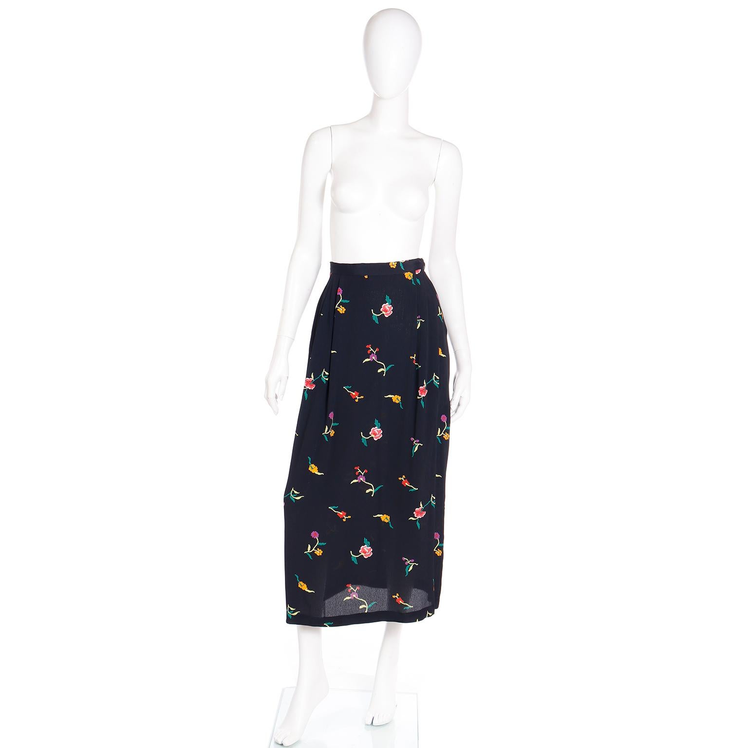 This vintage 1980's Norma Kamali Skirt is in a pretty printed floral pattern with pink, yellow and red flowers with green stems on a black background. We love vintage Norma Kamali pieces and this skirt would be such a great addition to any