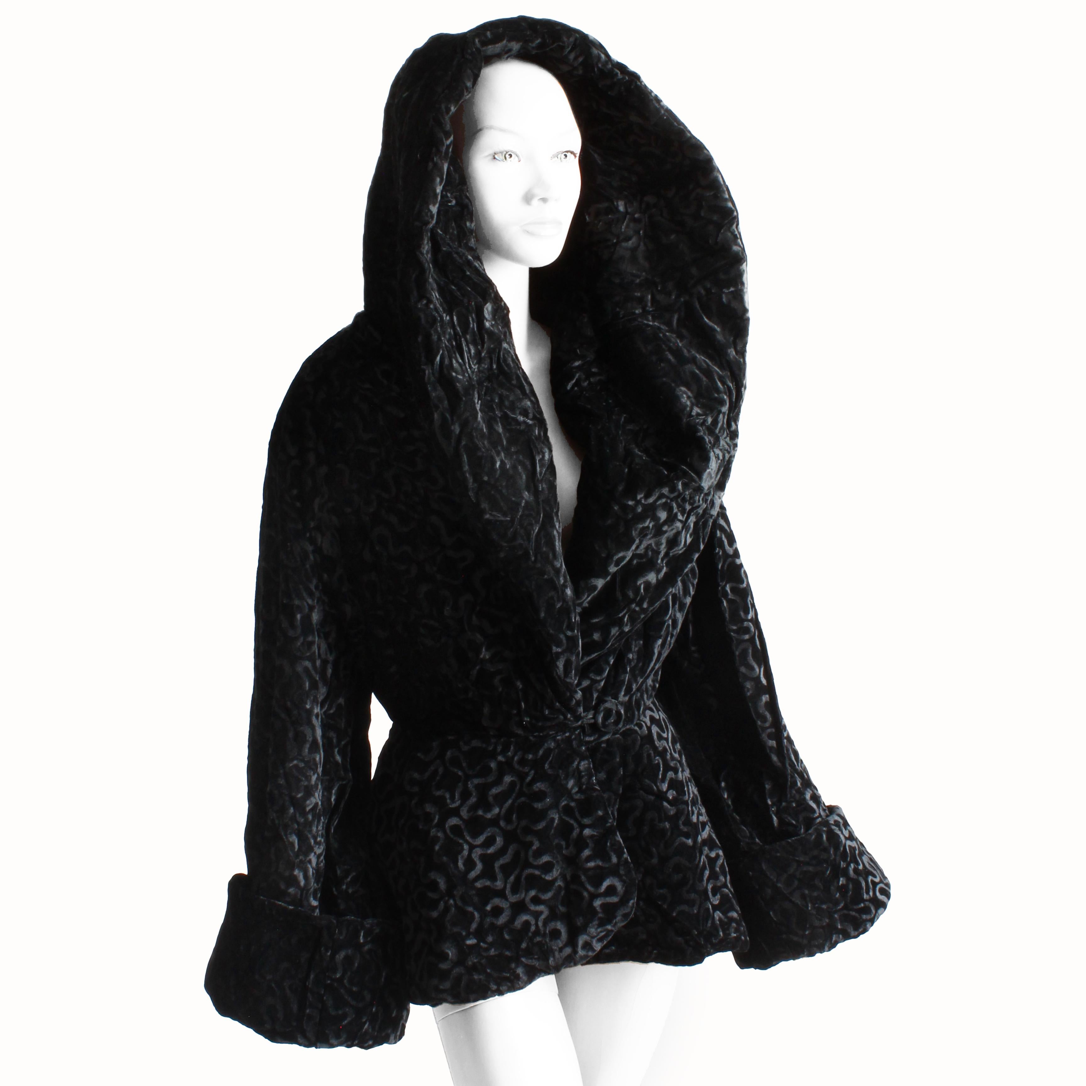 Preowned, vintage Norma Kamali jacket with massive shawl collar, likely made in the 80s.  Made from black velvet with a swirling burn out pattern, it fastens at the waist with a velvet-covered button and flares at the hem.  The sleeves have been