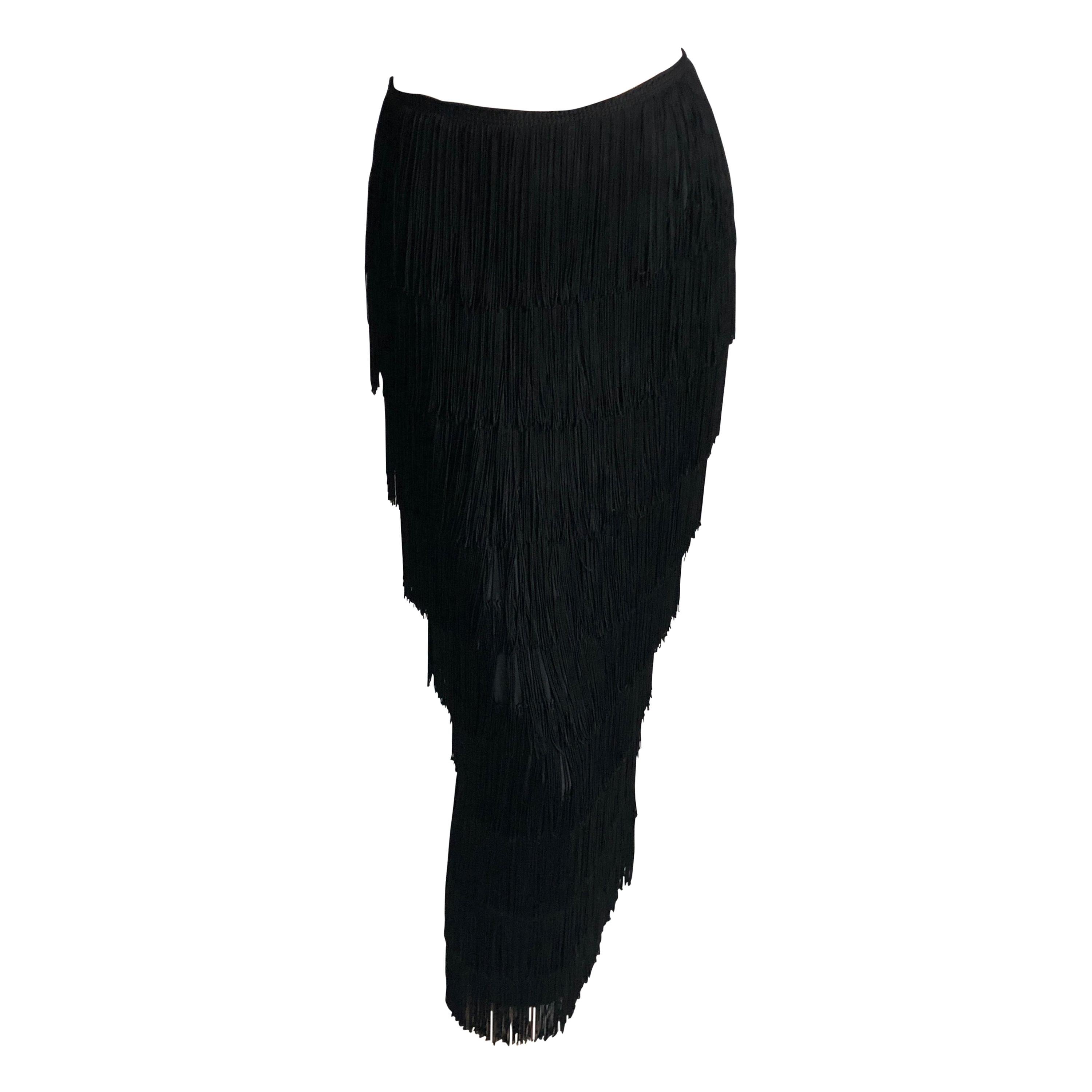 Authentic, preowned, vintage Norma Kamali OMO Long Skirt with Tiered Black Fringe, likely made in the late 80s.  The tiers of fringe create fabulous movement on this piece (see images 2 & 3, where we've screen grabbed some video).  Fully-lined;