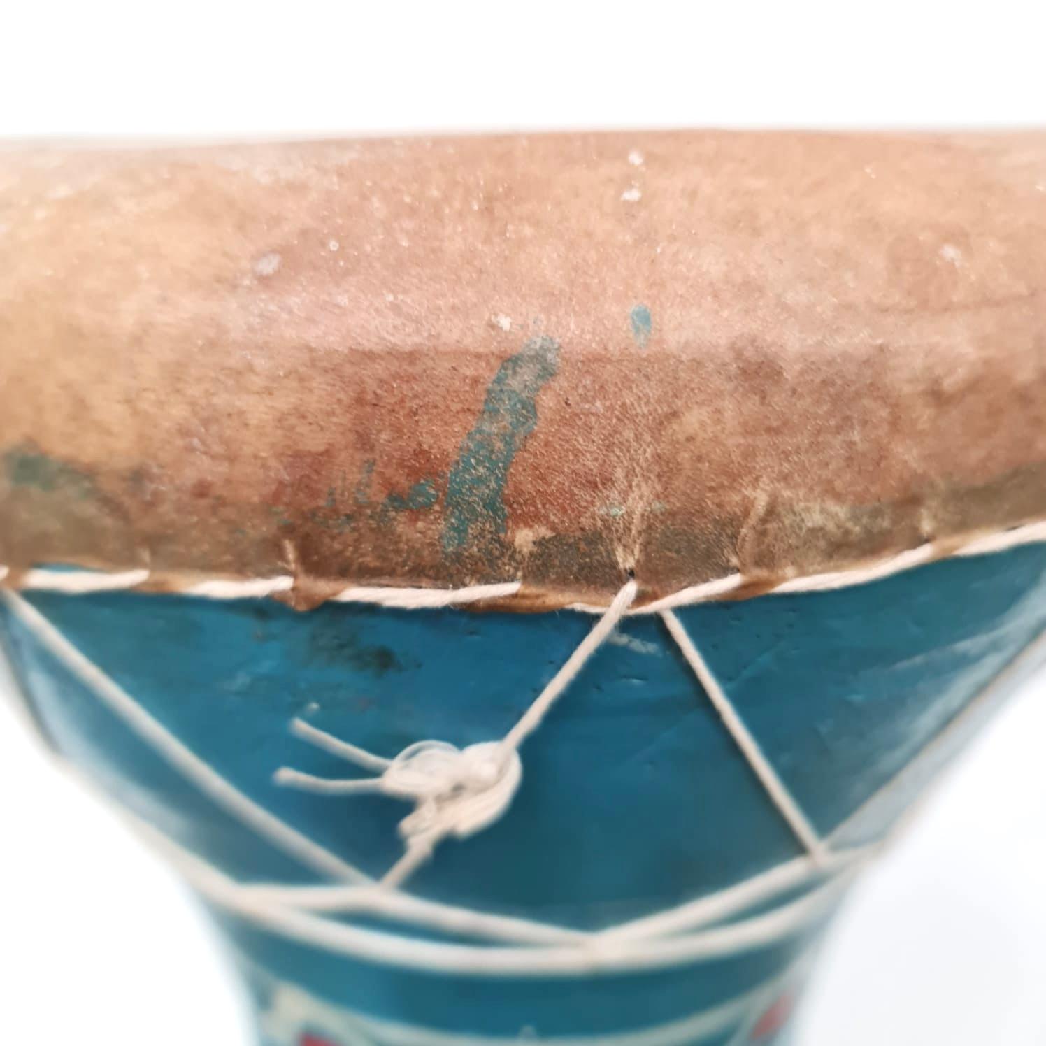 Handmade North African Clay Drum. A delight to see, touch and play. Made in the traditional method with a spun clay shell, claf skin and hand painted floral motif. Perfect as a small sidetable or accent piece on the floor or sideboard. Date of