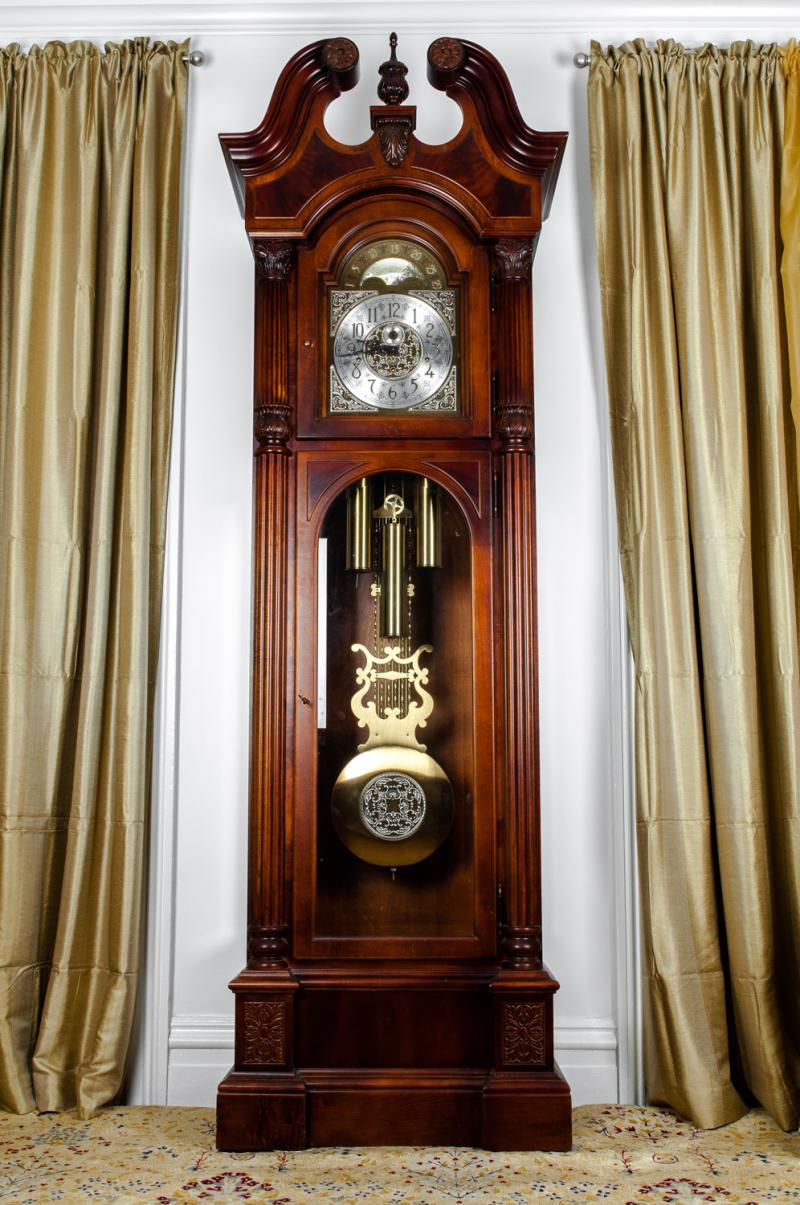 American Sheraton style long case clock with silvered dial and raised brass with Arabic numerals and pierced brass spandrils, with chime (Whittington) or silent option five graduated silvered brass tubes three suspended brass weights contained in a