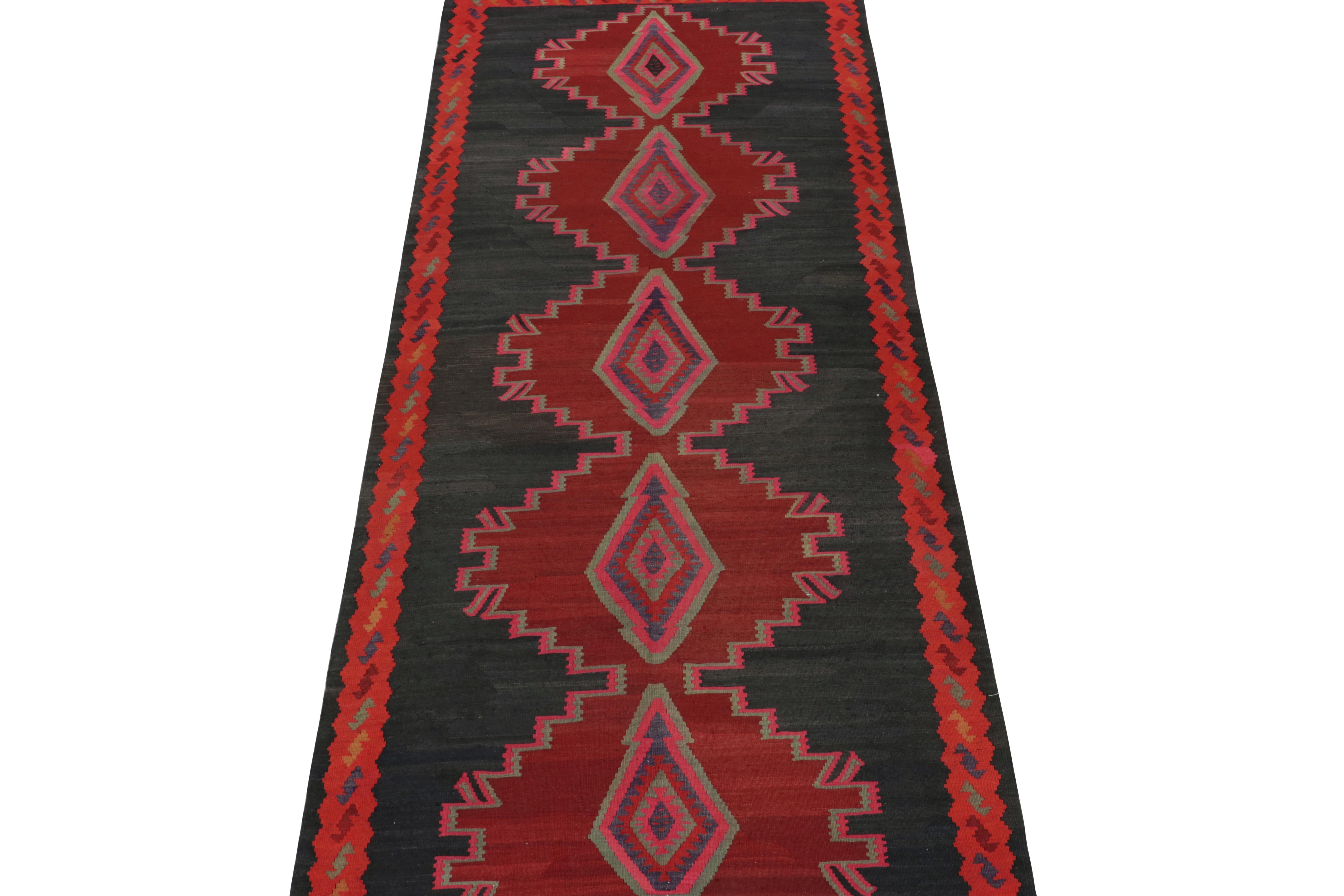 This vintage 5x13 Persian Kilim is a unique tribal rug for its period - hailing from Northwestern Persian from Azerbaijan. Handwoven in wool, it’s believed to originate in Meshkin circa 1950-1960.

Further on the Design:

The charcoal black open