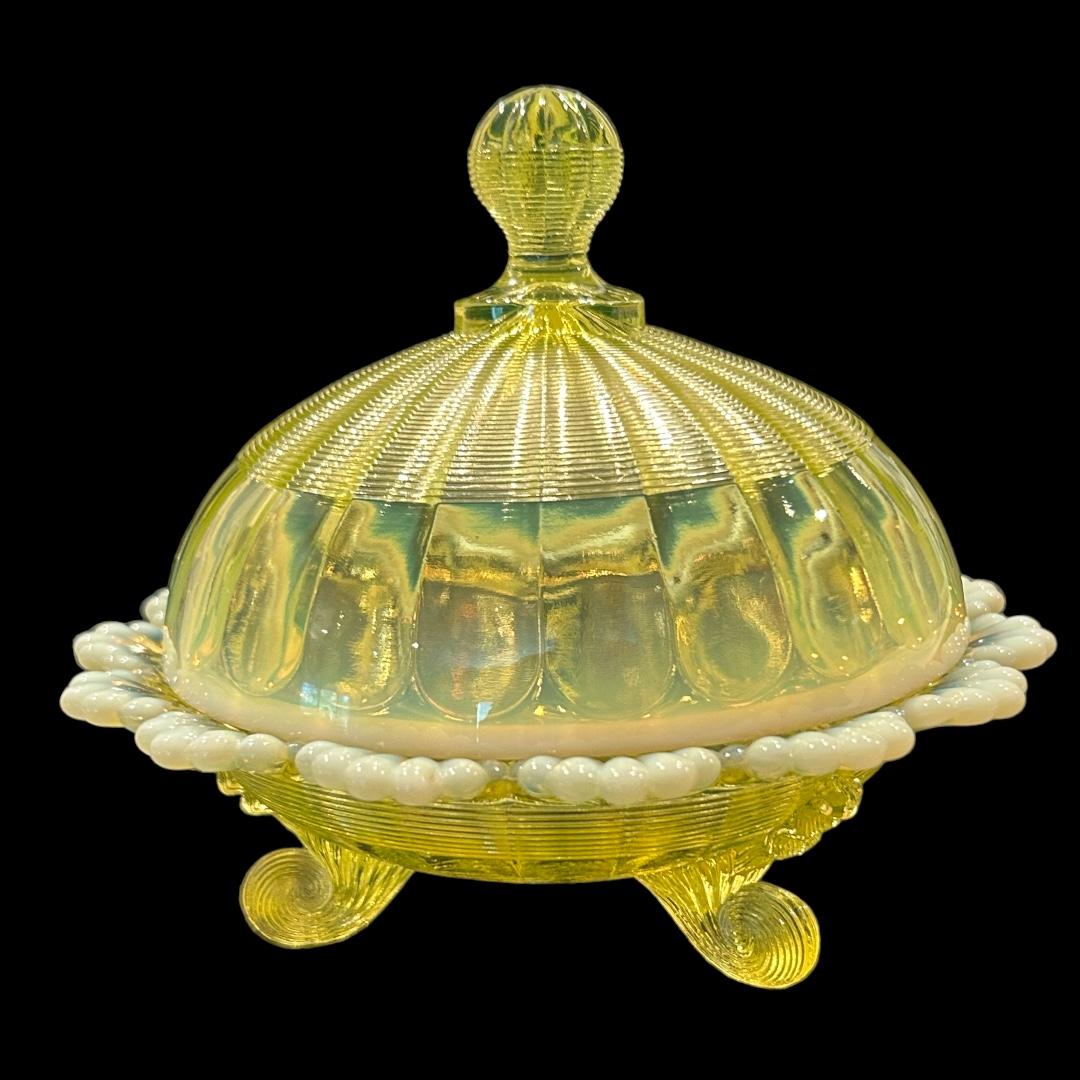 Excellent condition! Vaseline opalescent covered butter dish made by The Northwood Company; “Klondike” pattern; ornate design with scrolled feet; circa 1890s.