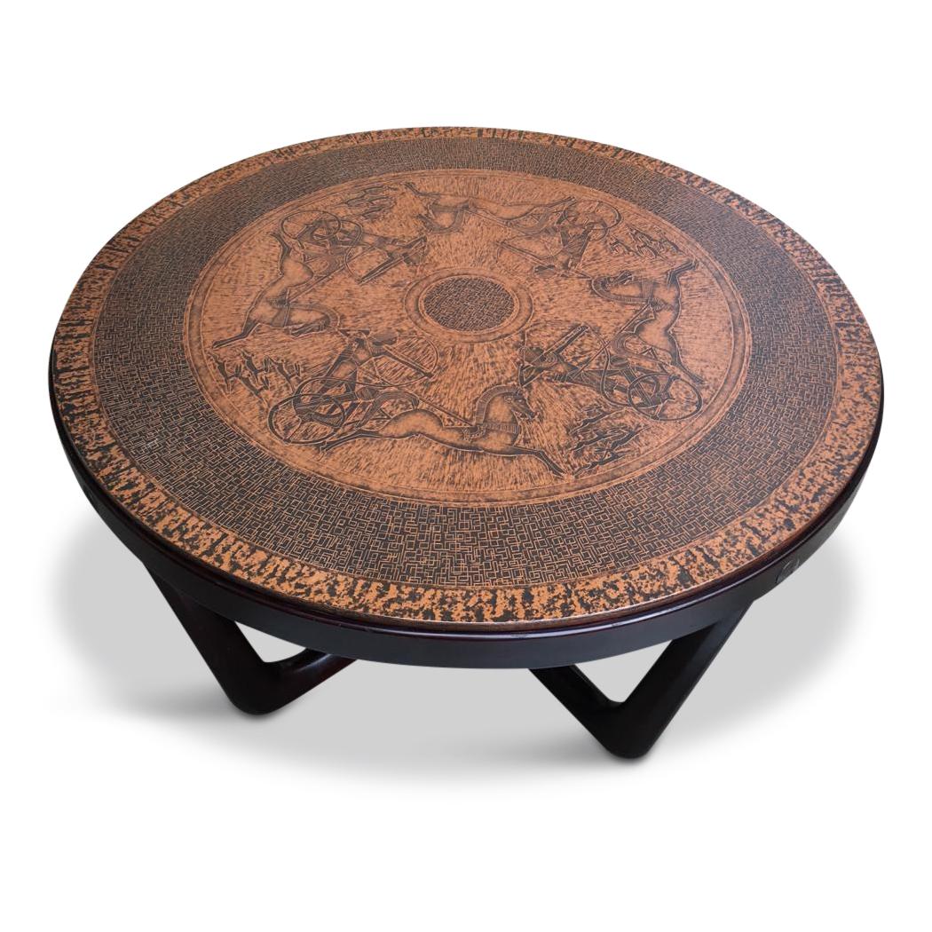 This coffee table features a stamped copper top with neo-Egyptian themes. Crafted by Vad Trevare Norge, 1970s. Base in solid, stained dark wood.

There are some minor signs of use on a wood, but the overall table condition is very