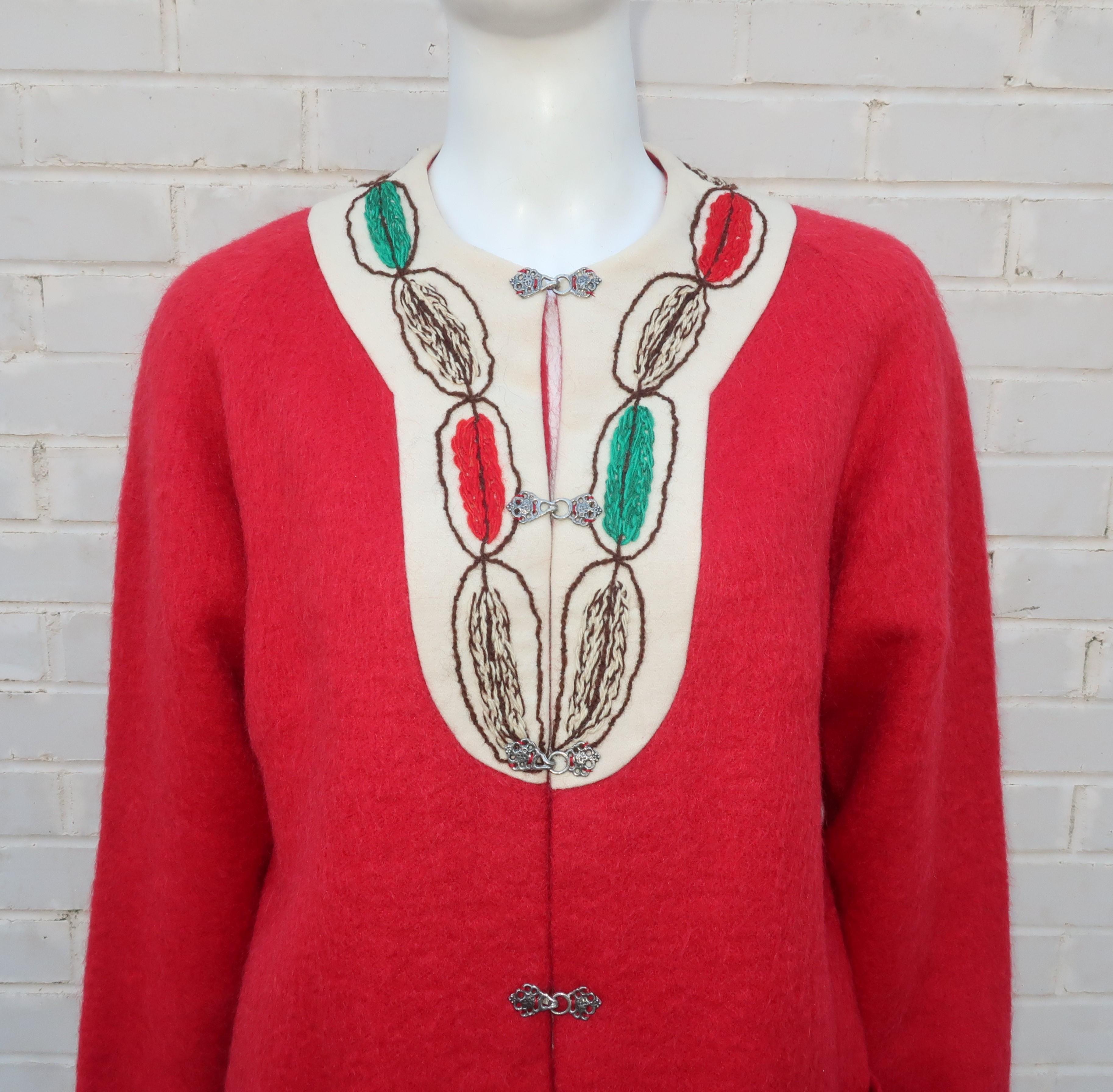 Comfy, cozy and cute!  This C.1960 Fjelstad red mohair jacket is an adorable look to pair with jeans and perfect for layering with turtlenecks or t-shirts.  The jacket features pewter frog style closures at the front, a yarn embroidered bib and