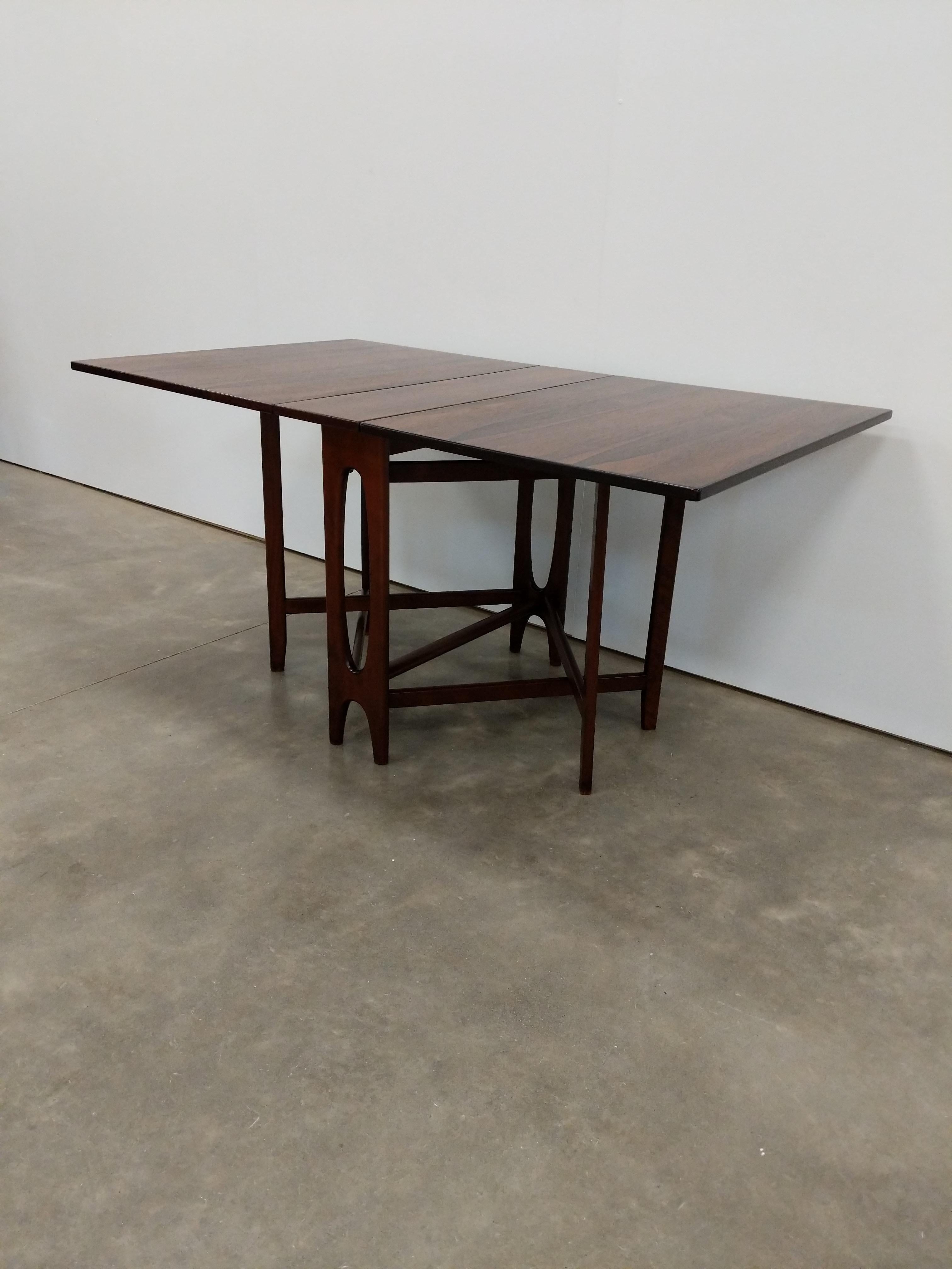 Vintage Norwegian mid century modern rosewood collapsible drop leaf dining table.

Marked 