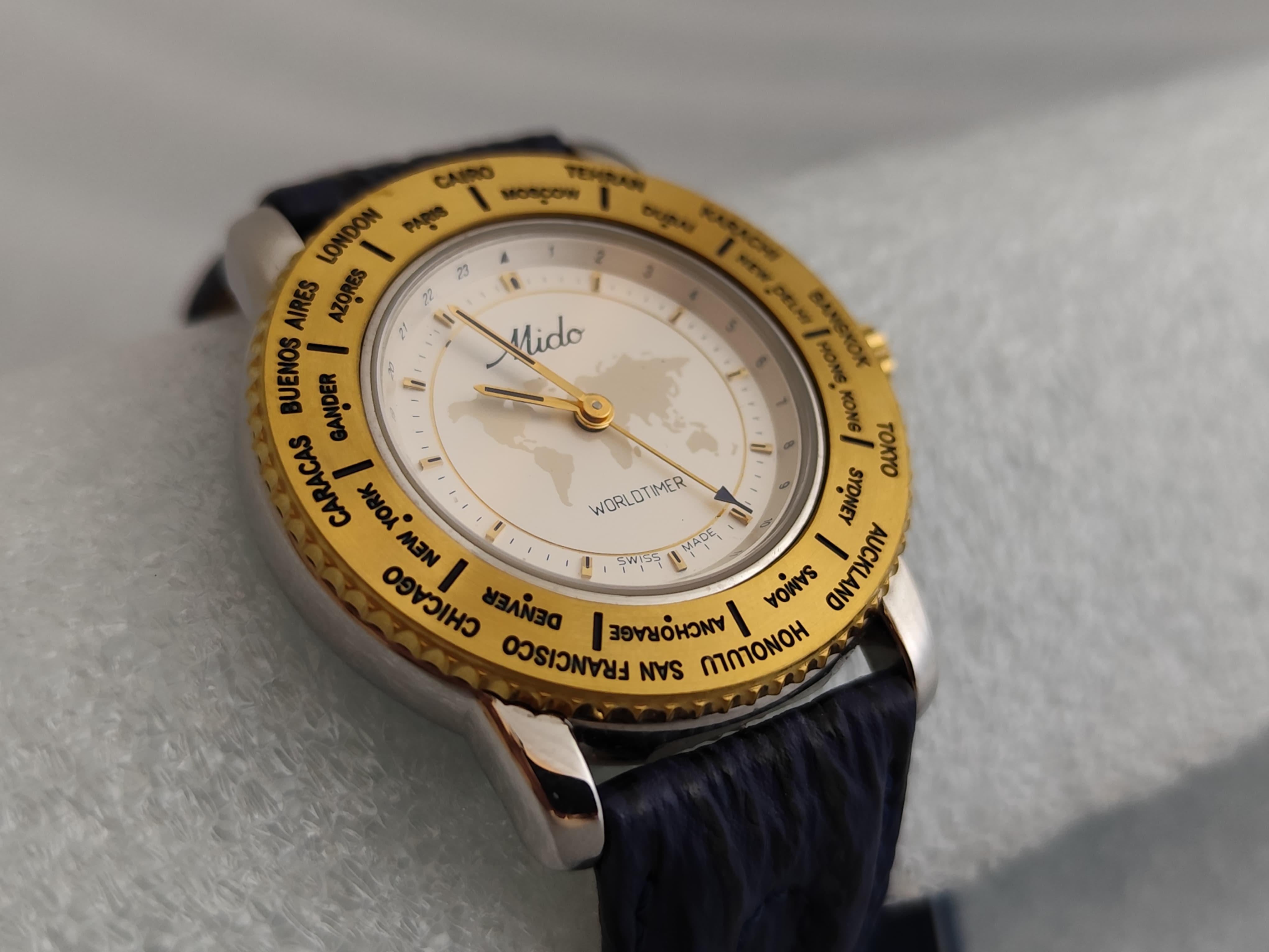 Brand: Mido

Model: Worldtimer

Reference Number: 5200

What's Included : Tag - Outer Box -Inner Box

Country Of Manufacture: Switzerland

Movement: Quartz

Case Material: Stainless steel / Gold Plated

Measurements : Case width: 39 mm. (without