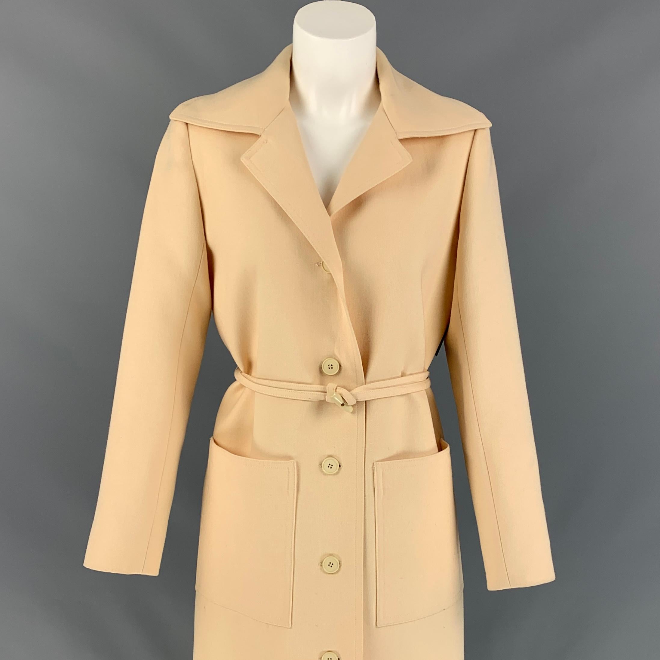 Nouvelle Boutique by HUBERT de GIVENCHY coat comes in a cream twill material with a full liner featuring a toggle belted detail, patch pockets, single back vent, large lapel, and a buttoned closure. Made in France. 

Good Pre-Owned Condition. Fabric